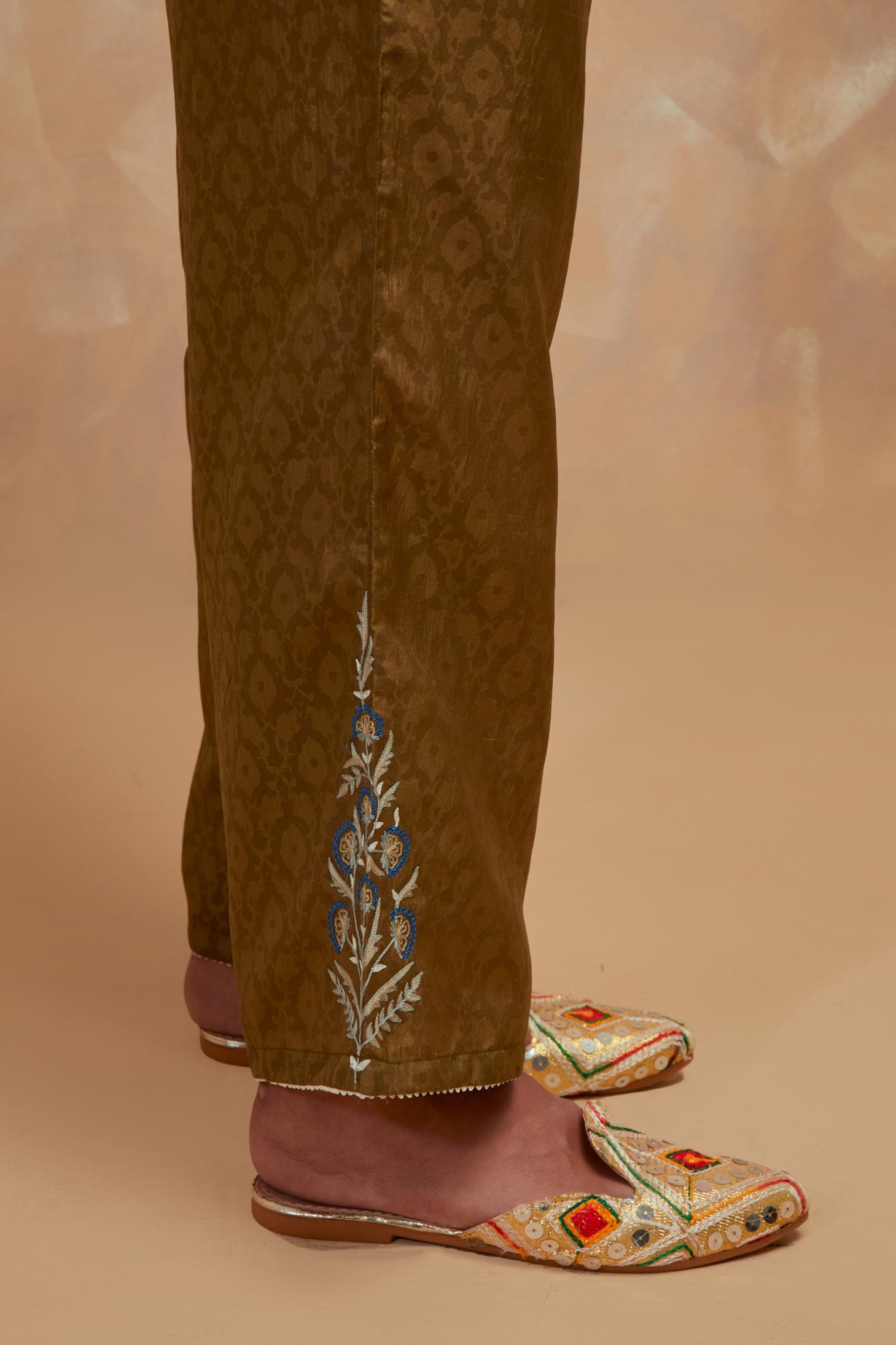 Olive green silk straight pants with all-over hand block print, highlighted with embroidered boota at hem.