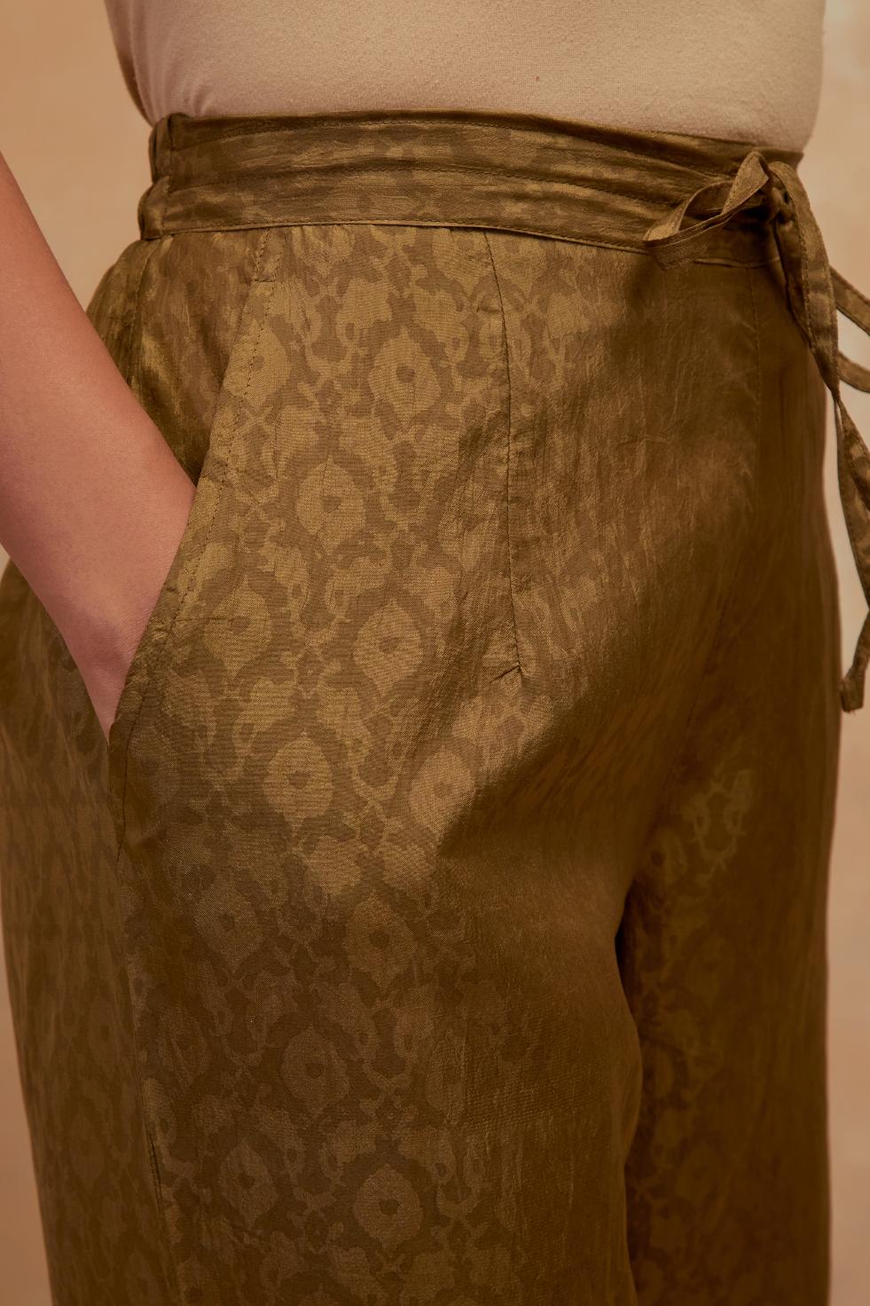 Olive green silk straight pants with all-over hand block print, highlighted with embroidered boota at hem.