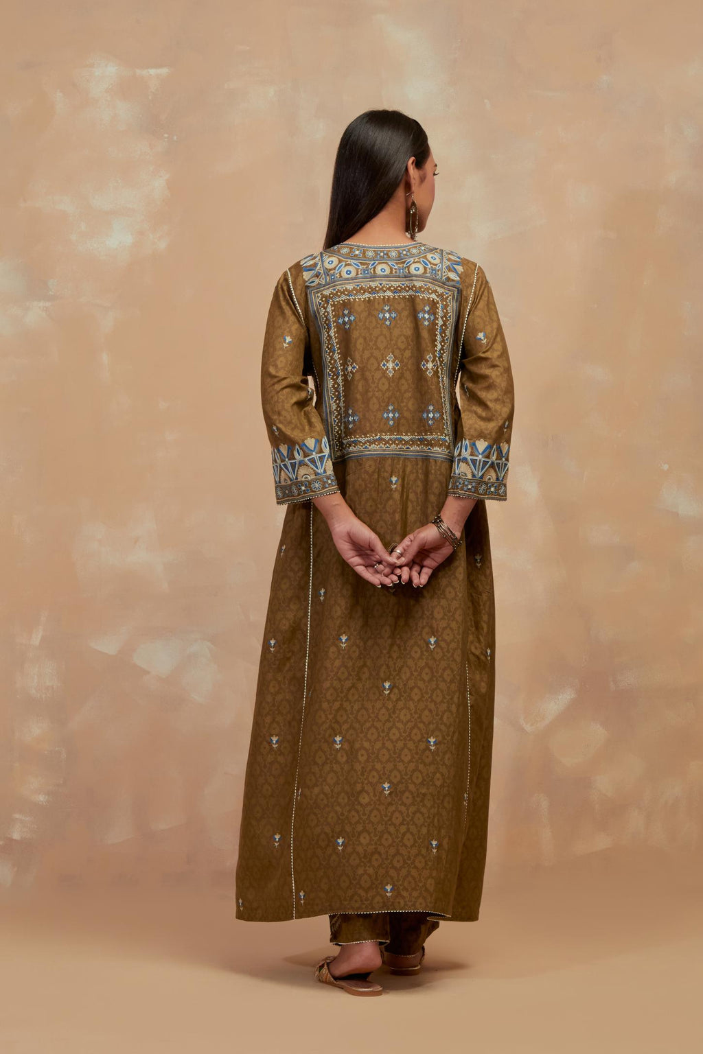 Olive green silk hand block printed A-line long kurta set with all-over multi colored thread embroidery.