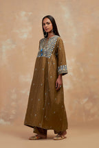 Olive green silk hand block printed A-line long kurta set with all-over multi colored thread embroidery.