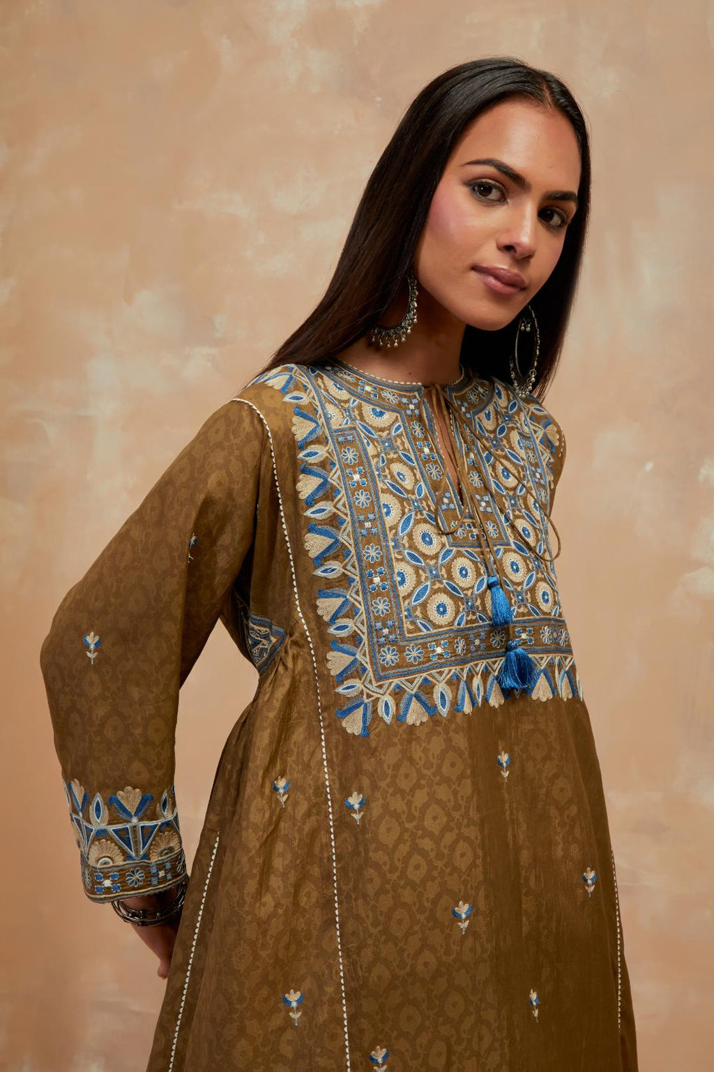 Olive green silk hand block printed A-line long kurta set with all-over multi colored thread embroidery.