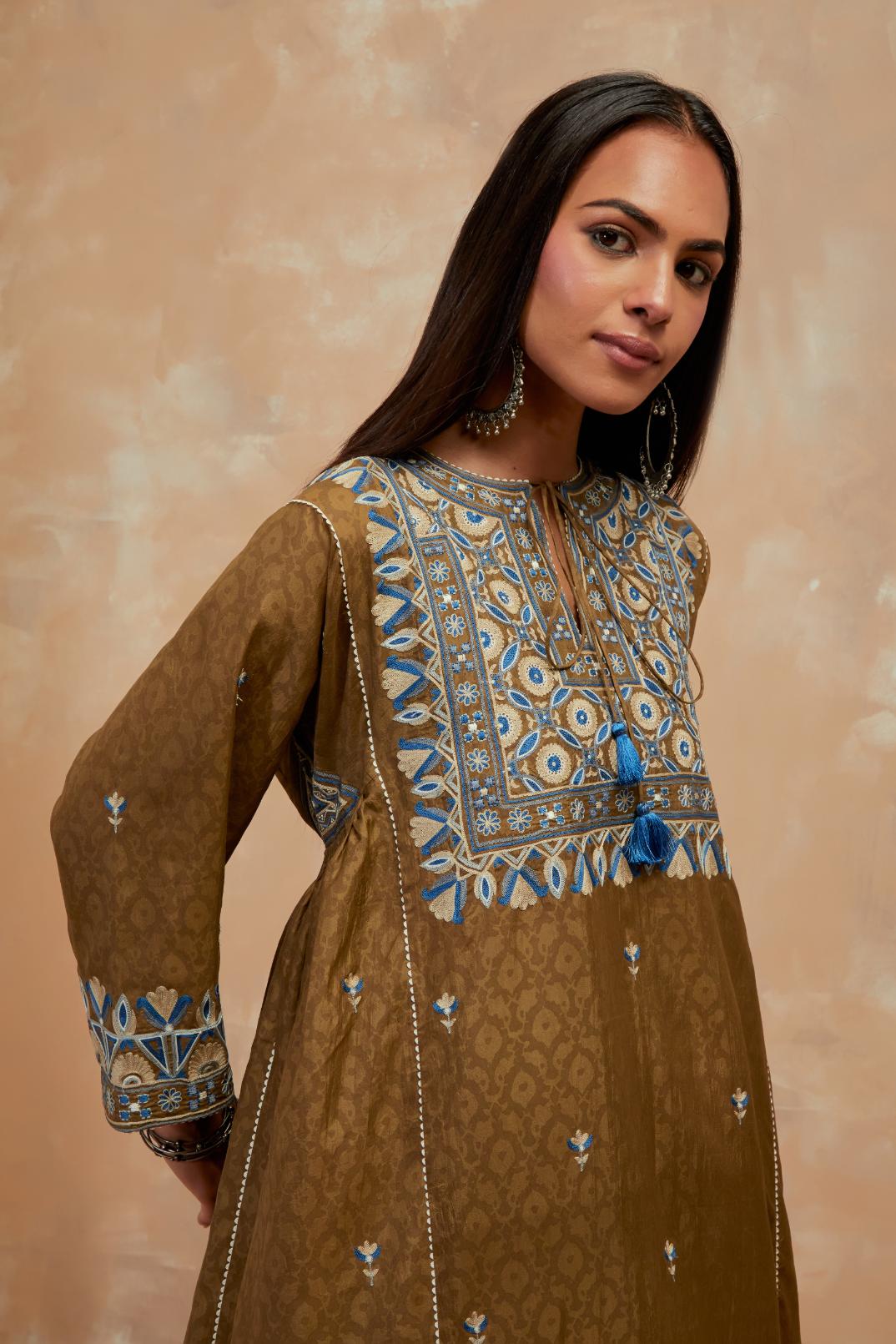 Olive green silk hand block printed A-line long kurta set with all-over multi colored thread embroidery.