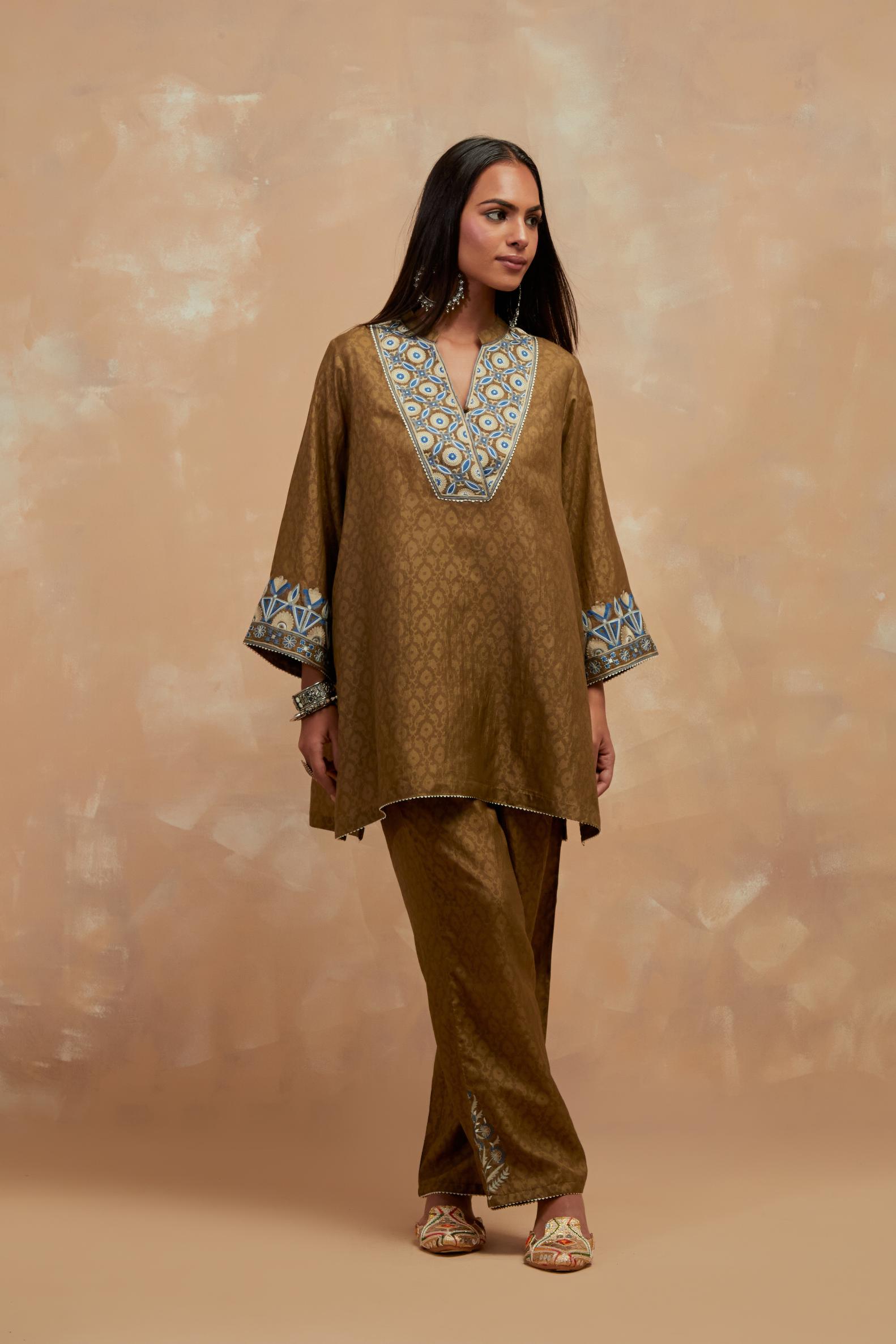 Olive green silk hand block printed short top, highlighted with multi colored silk thread embroidery,  paired with Olive green silk straight pants with all-over hand block print, highlighted with embroidered boota at hem.