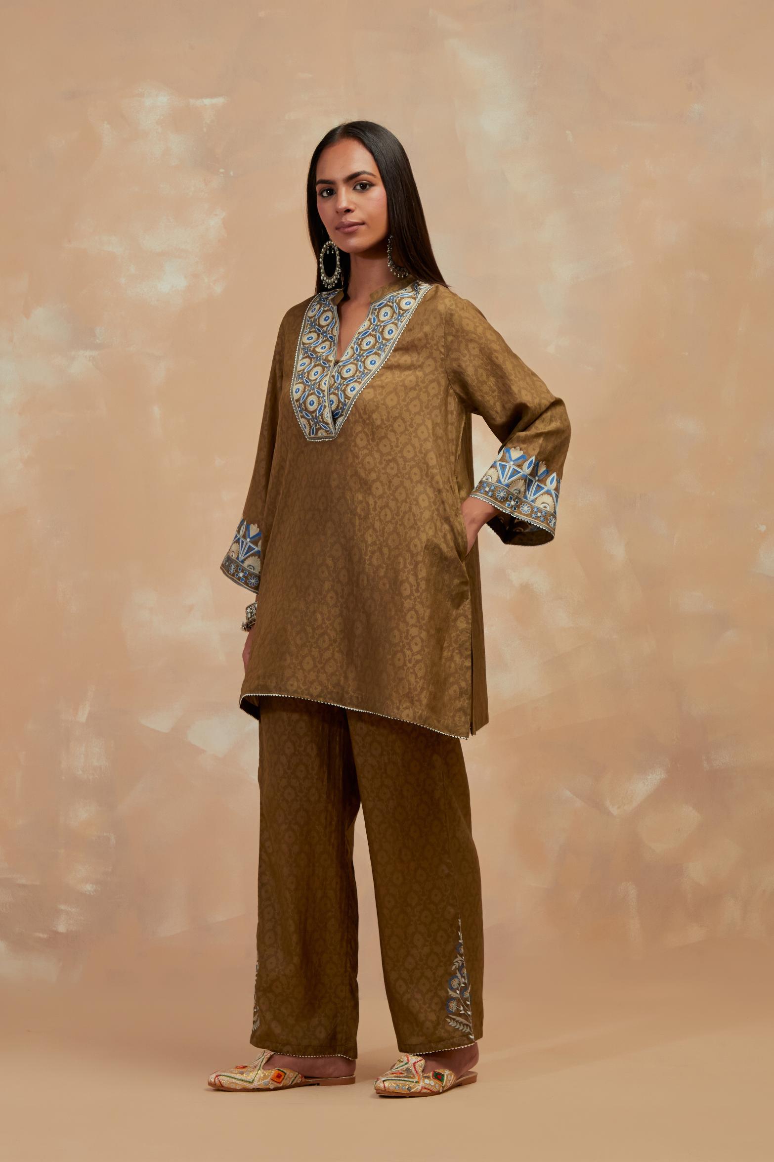 Olive green silk hand block printed short top, highlighted with multi colored silk thread embroidery,  paired with Olive green silk straight pants with all-over hand block print, highlighted with embroidered boota at hem.