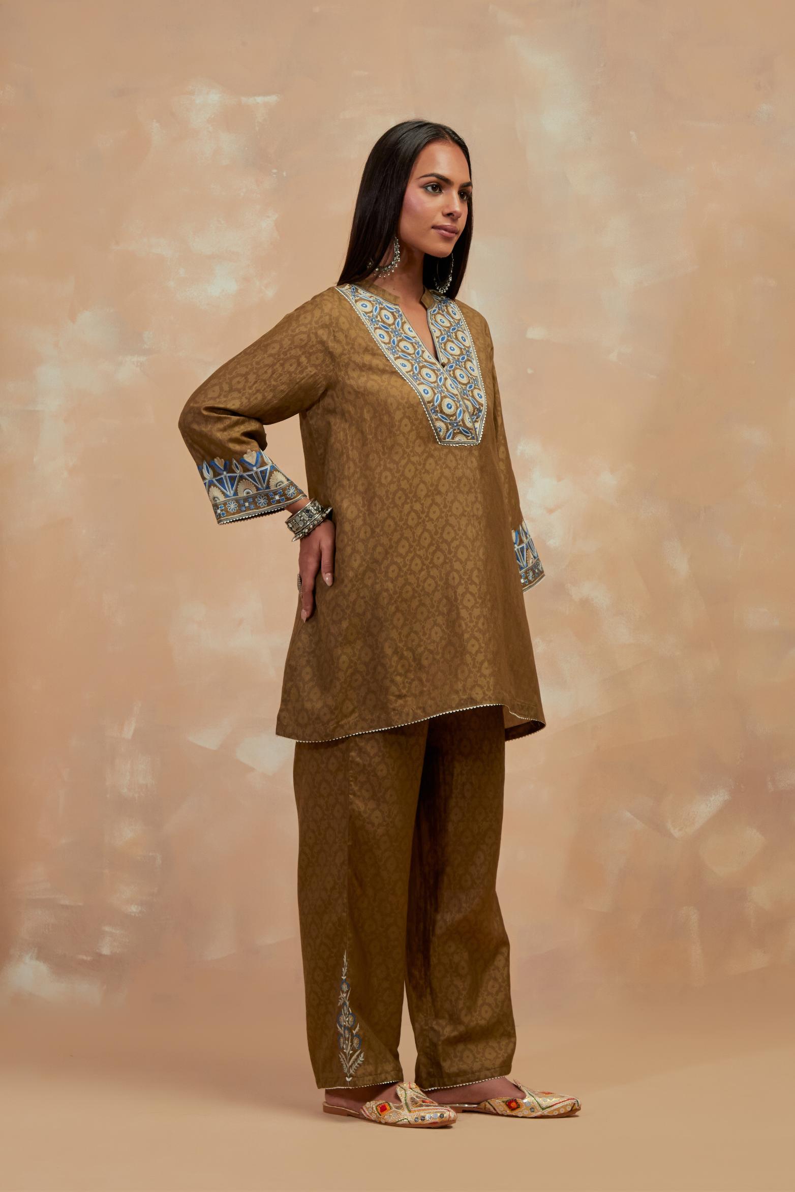 Olive green silk hand block printed short top, highlighted with multi colored silk thread embroidery,  paired with Olive green silk straight pants with all-over hand block print, highlighted with embroidered boota at hem.