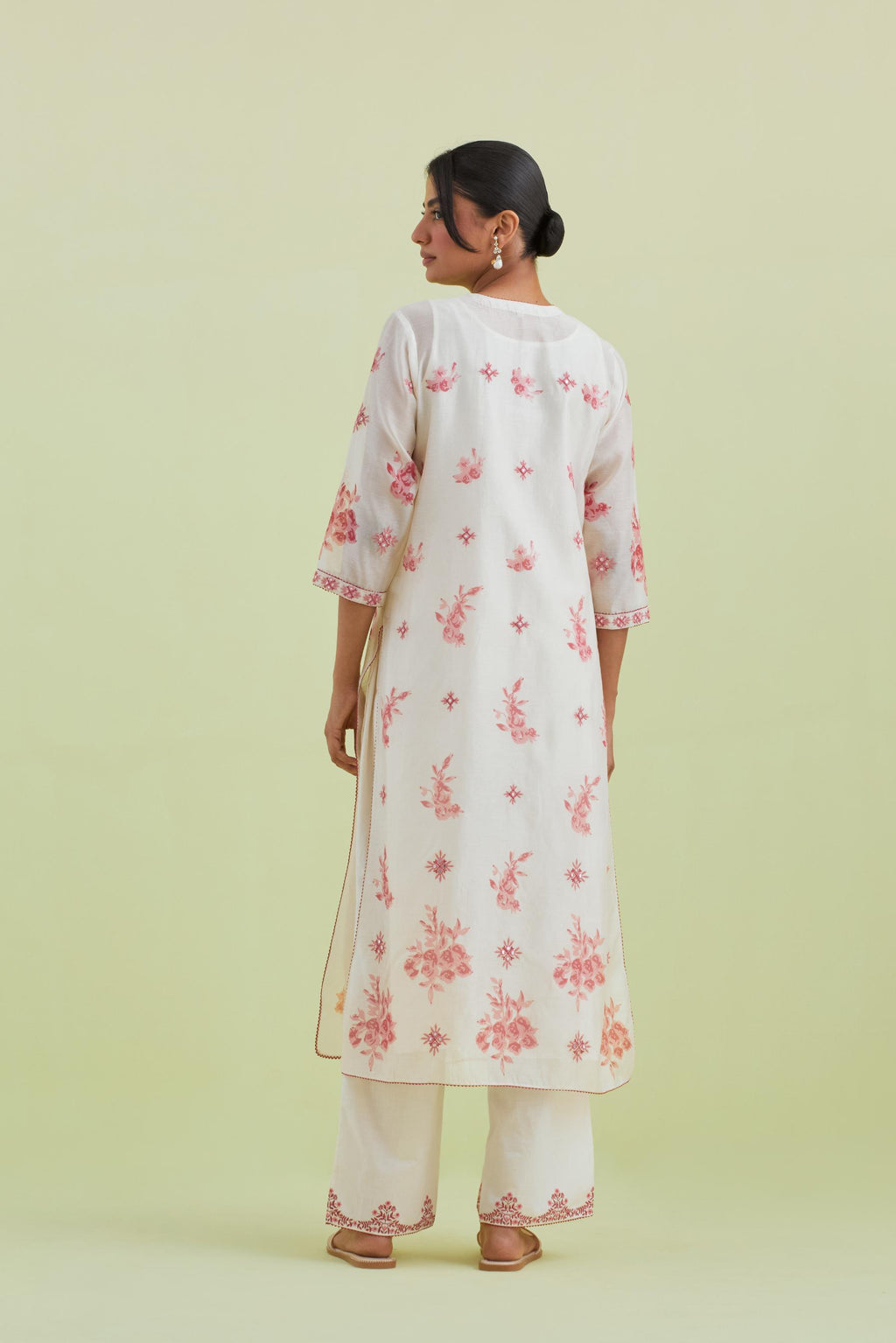 Pink and off-white silk chanderi hand block printed straight kurta set with pin tucks at yoke and all-over pink colored flower.