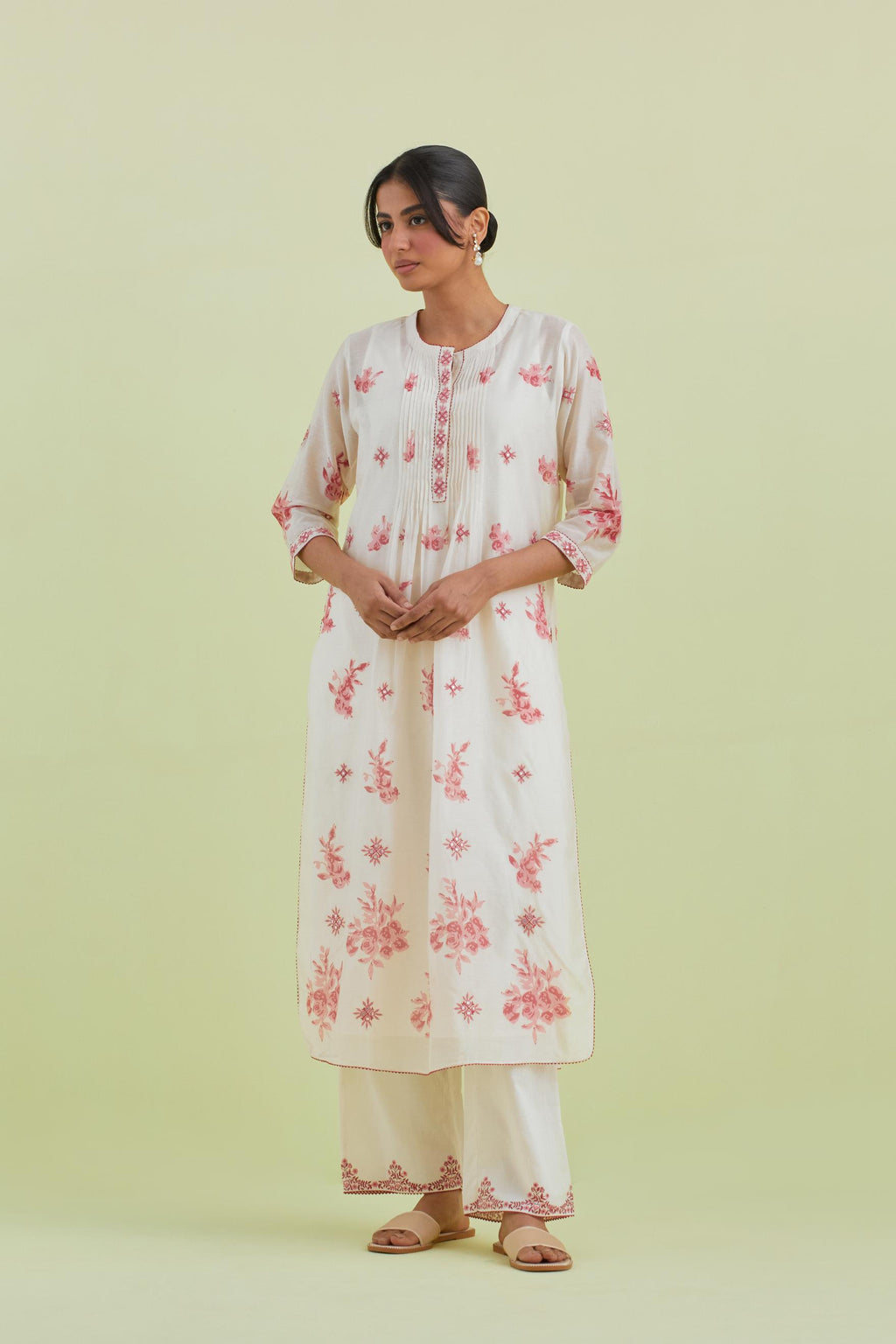 Pink and off-white silk chanderi hand block printed straight kurta set with pin tucks at yoke and all-over pink colored flower.