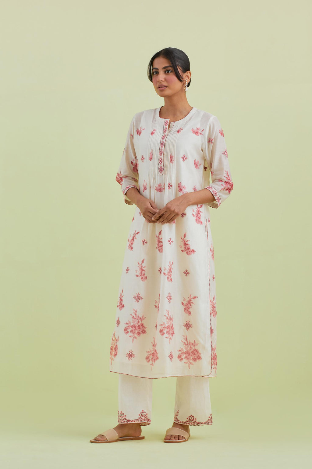 Pink and off-white silk chanderi hand block printed straight kurta set with pin tucks at yoke and all-over pink colored flower.