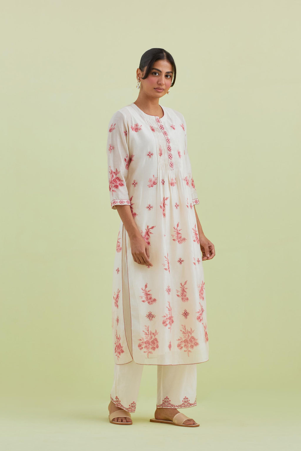 Pink and off-white silk chanderi hand block printed straight kurta set with pin tucks at yoke and all-over pink colored flower.