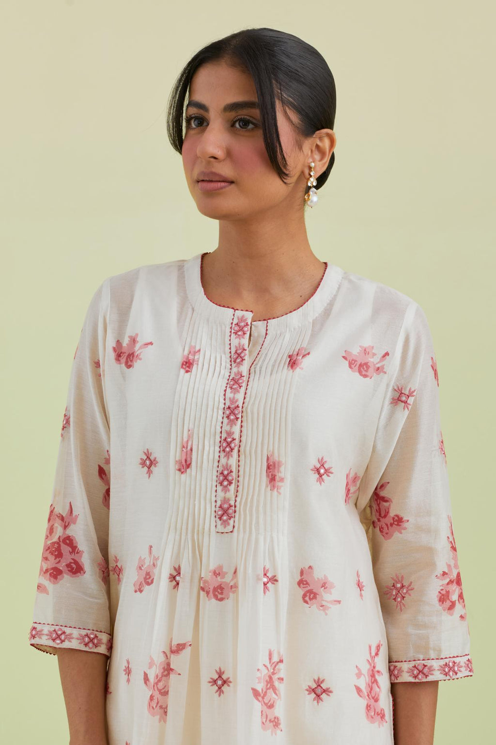 Pink and off-white silk chanderi hand block printed straight kurta set with pin tucks at yoke and all-over pink colored flower.