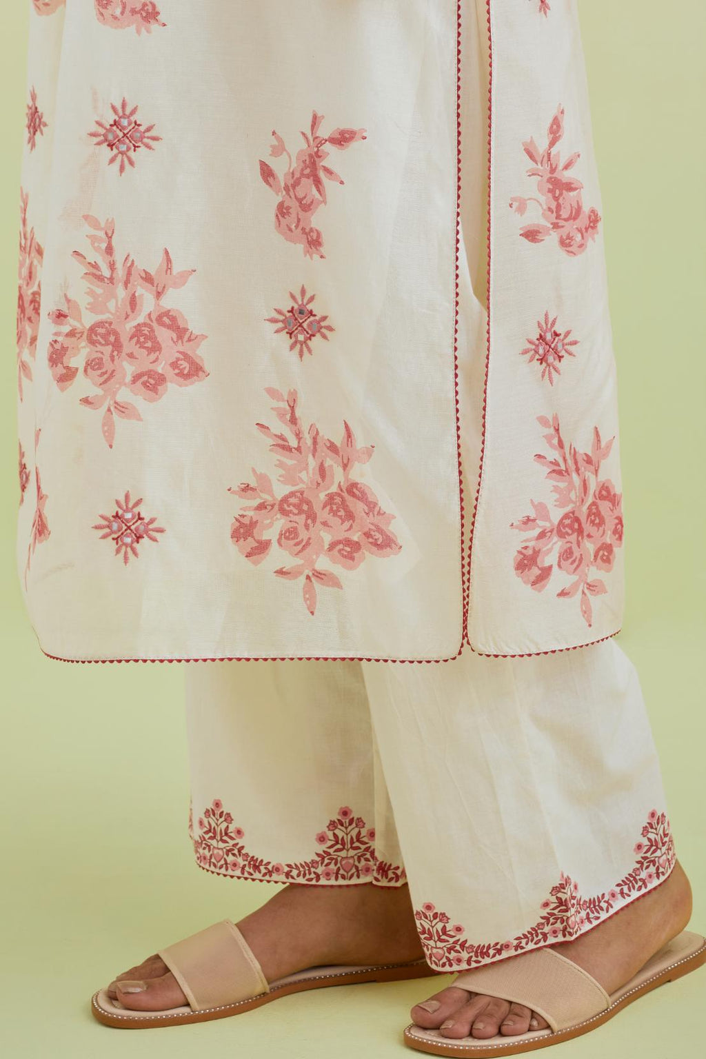 Pink and off-white silk chanderi hand block printed straight kurta set with pin tucks at yoke and all-over pink colored flower.