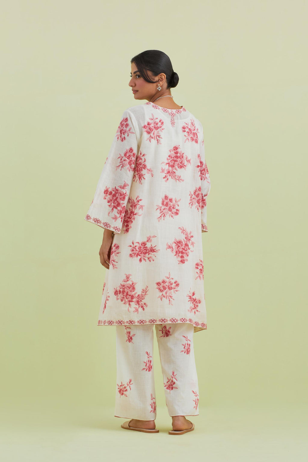 Pink and off-white cotton hand-block printed A-line short kurta set with round neck and asymmetric hem.