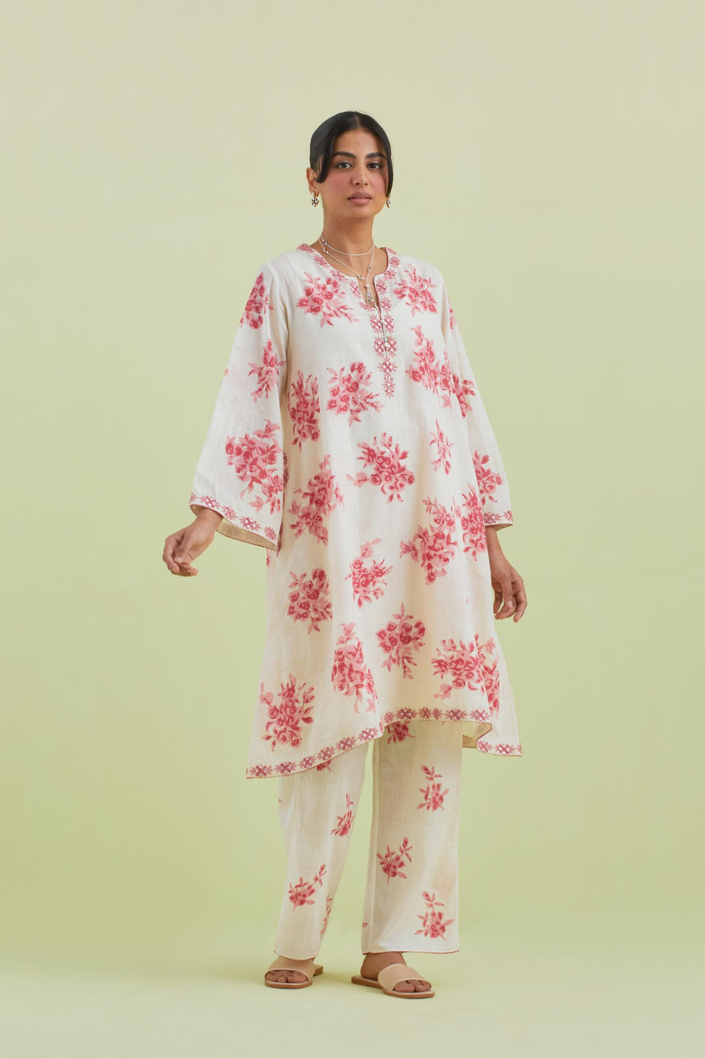 Pink and off-white cotton hand-block printed A-line short kurta set with round neck and asymmetric hem.