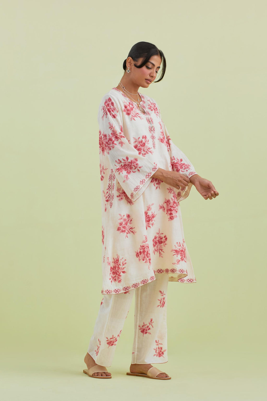 Pink and off-white cotton hand-block printed A-line short kurta set with round neck and asymmetric hem.