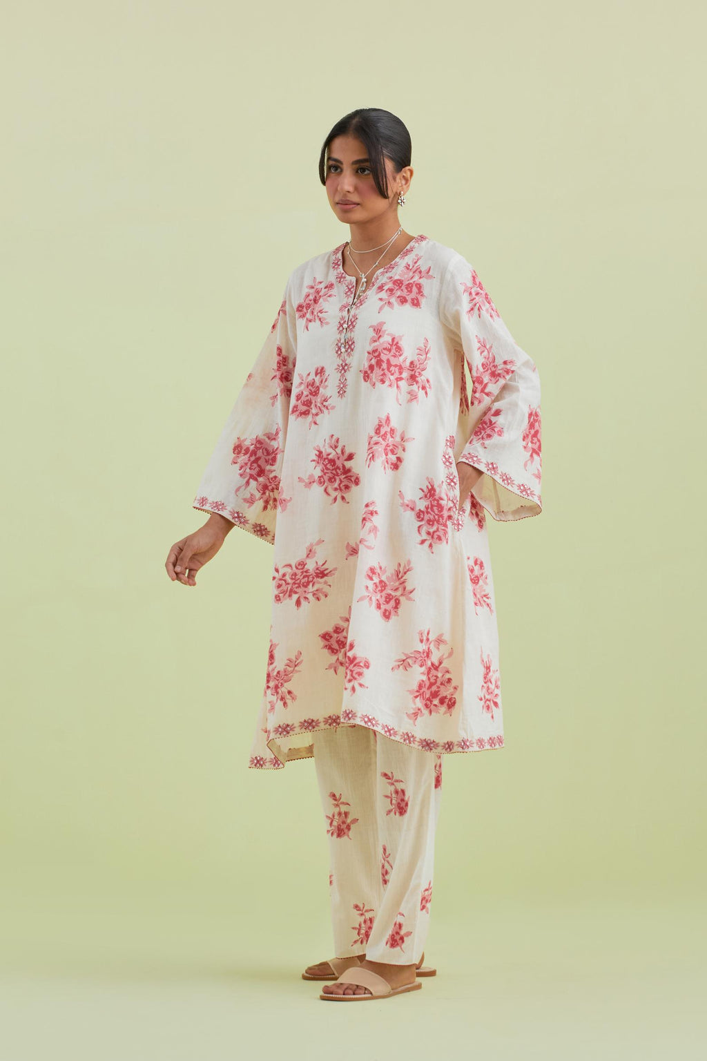 Pink and off-white cotton hand-block printed A-line short kurta set with round neck and asymmetric hem.