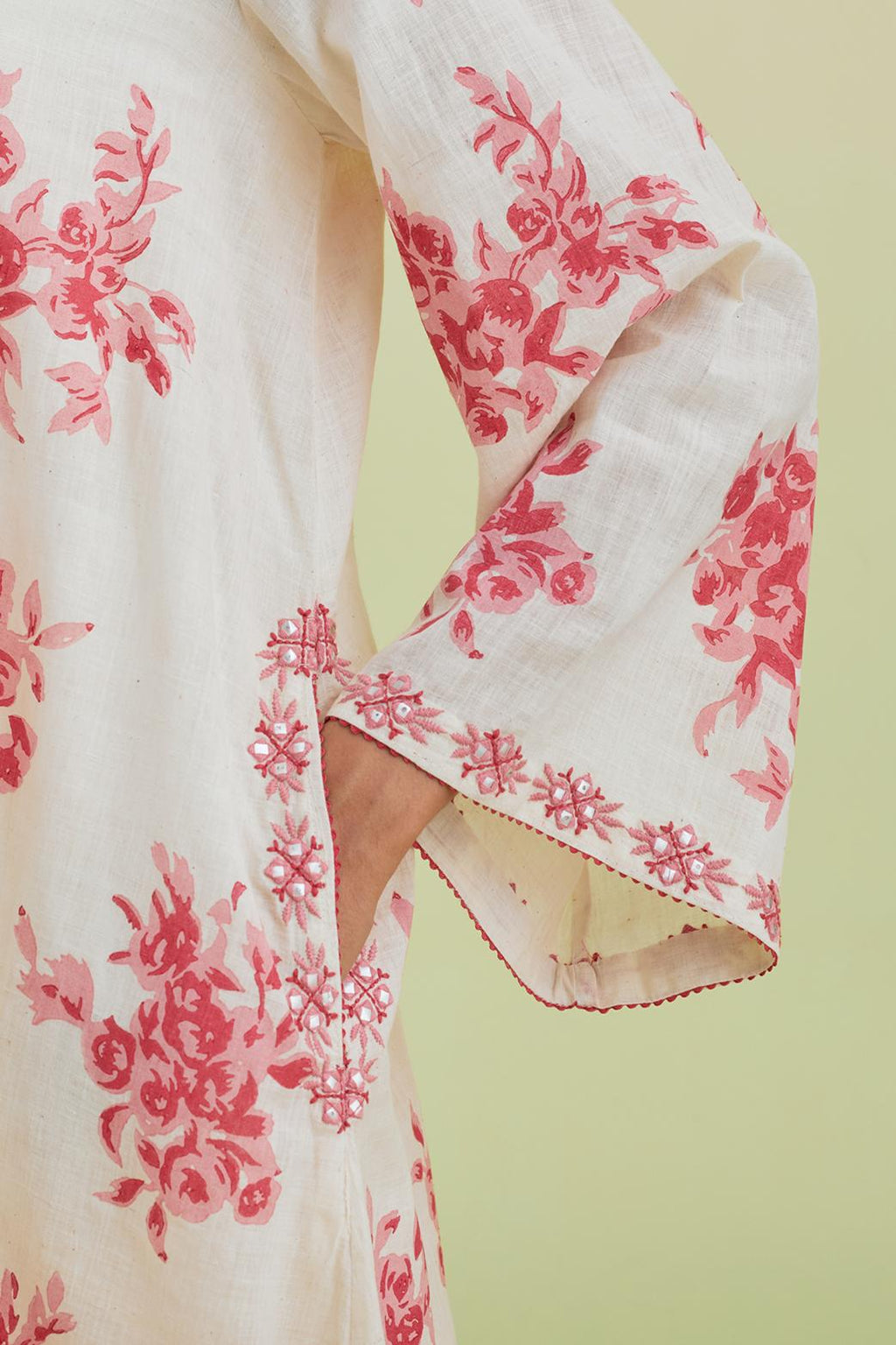 Pink and off-white cotton hand-block printed A-line short kurta set with round neck and asymmetric hem.