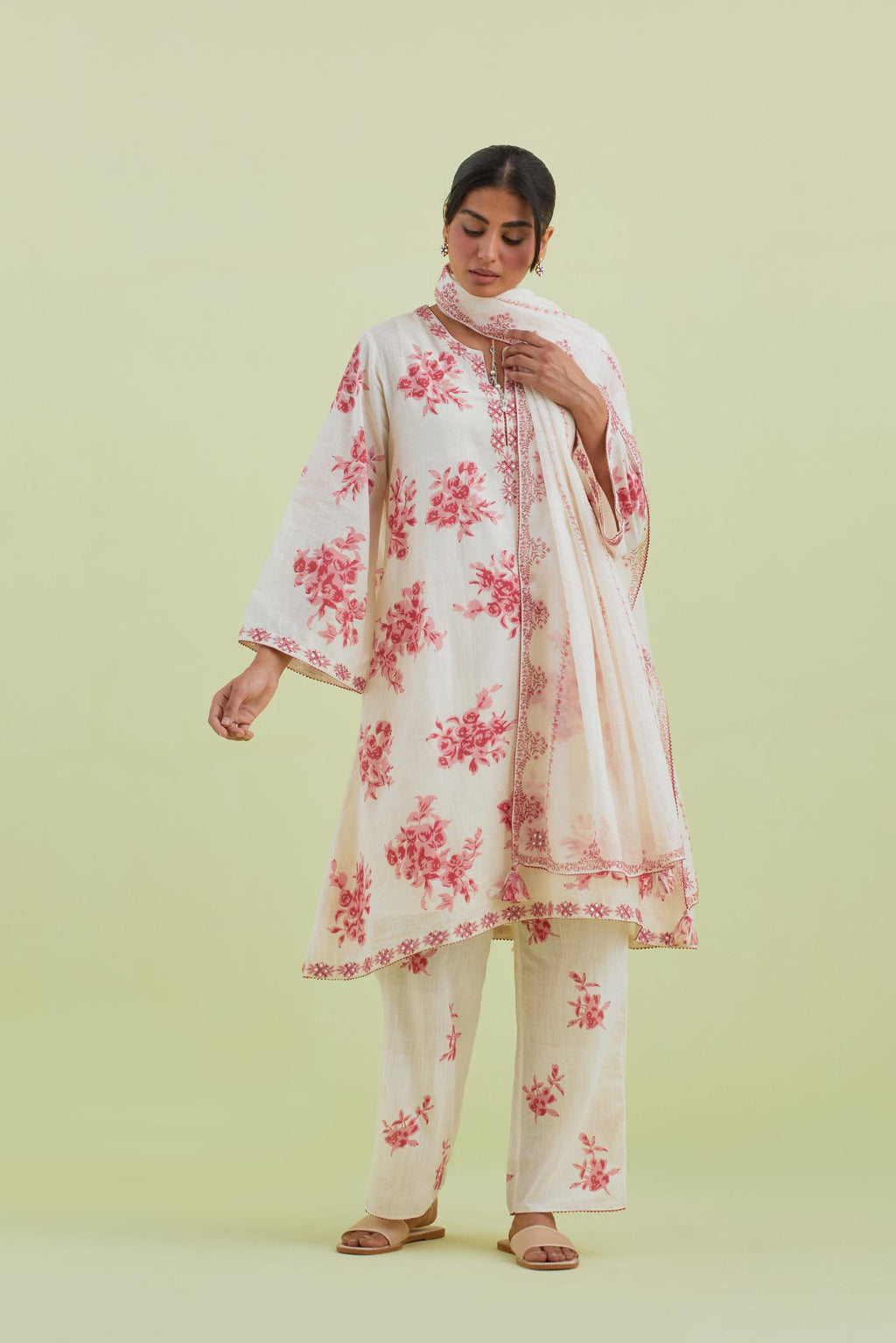 Pink and off-white cotton hand-block printed A-line short kurta set with round neck and asymmetric hem.