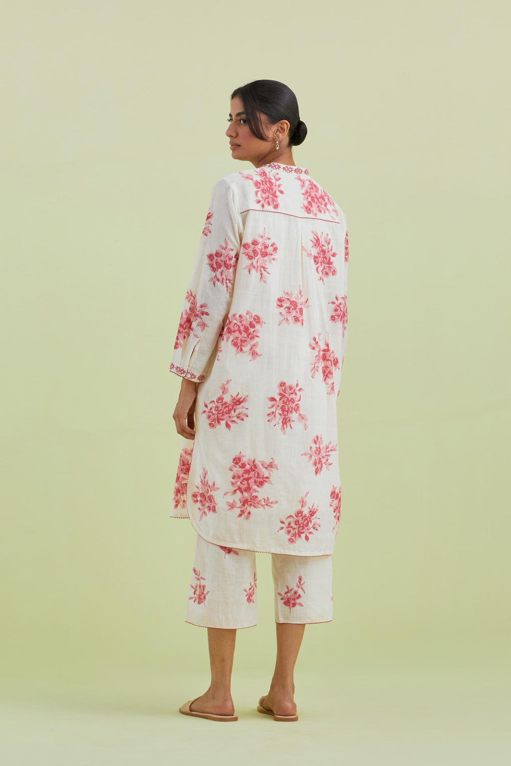 Pink and off-white cotton straight short kurta with all-over hand block print and embroidery at neck and sleeves, paired with off white straight ankle length pants with all-over pink colored floral boota hand-block print.