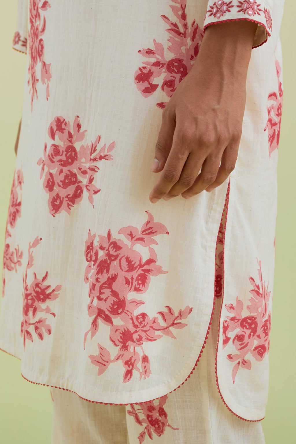 Pink and off-white cotton straight short kurta with all-over hand block print and embroidery at neck and sleeves, paired with off white straight ankle length pants with all-over pink colored floral boota hand-block print.