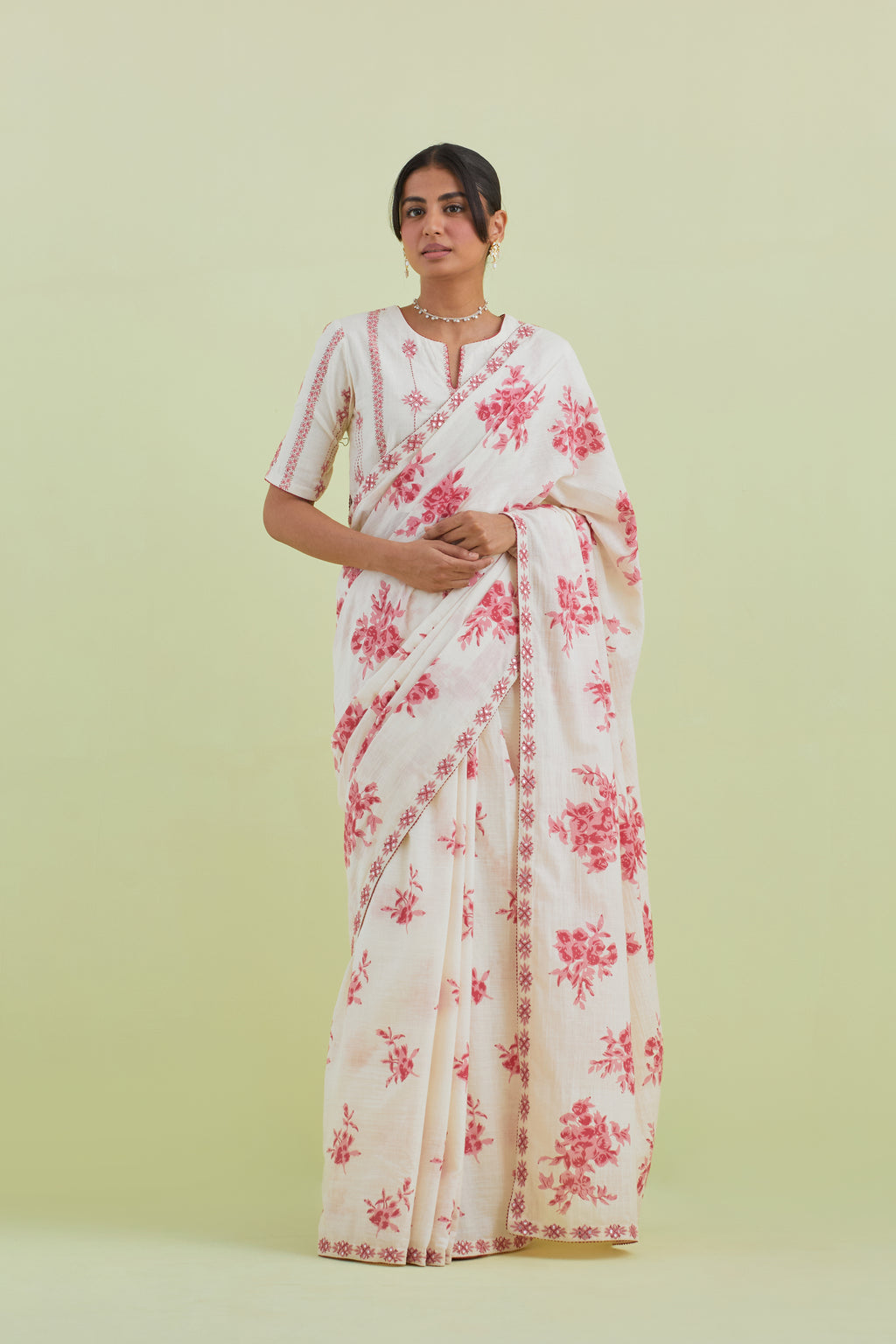 Pink & off-white handspun handwoven cotton hand-block printed saree set with pink thread and mirror embroidery at the edges.