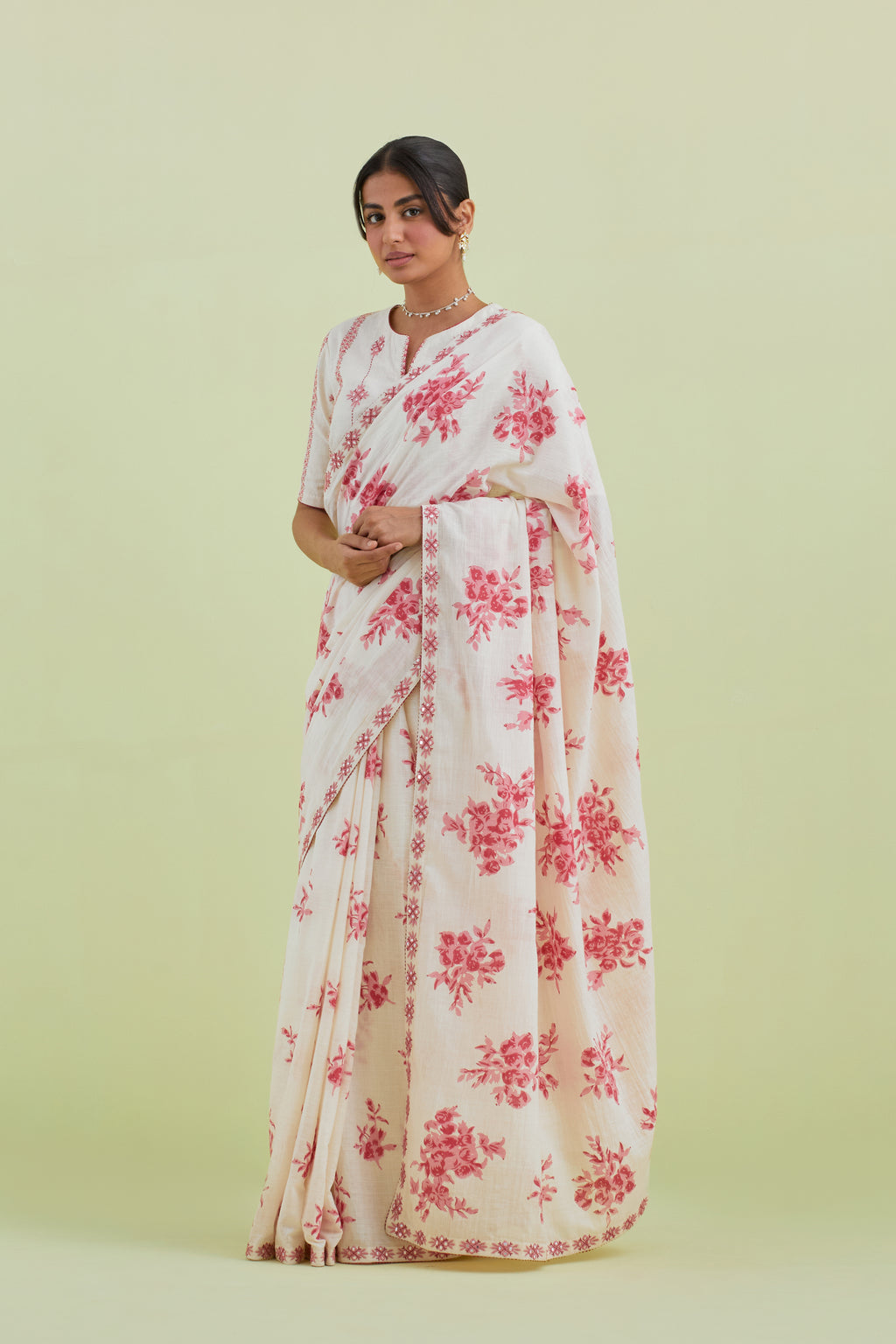 Pink & off-white handspun handwoven cotton hand-block printed saree set with pink thread and mirror embroidery at the edges.