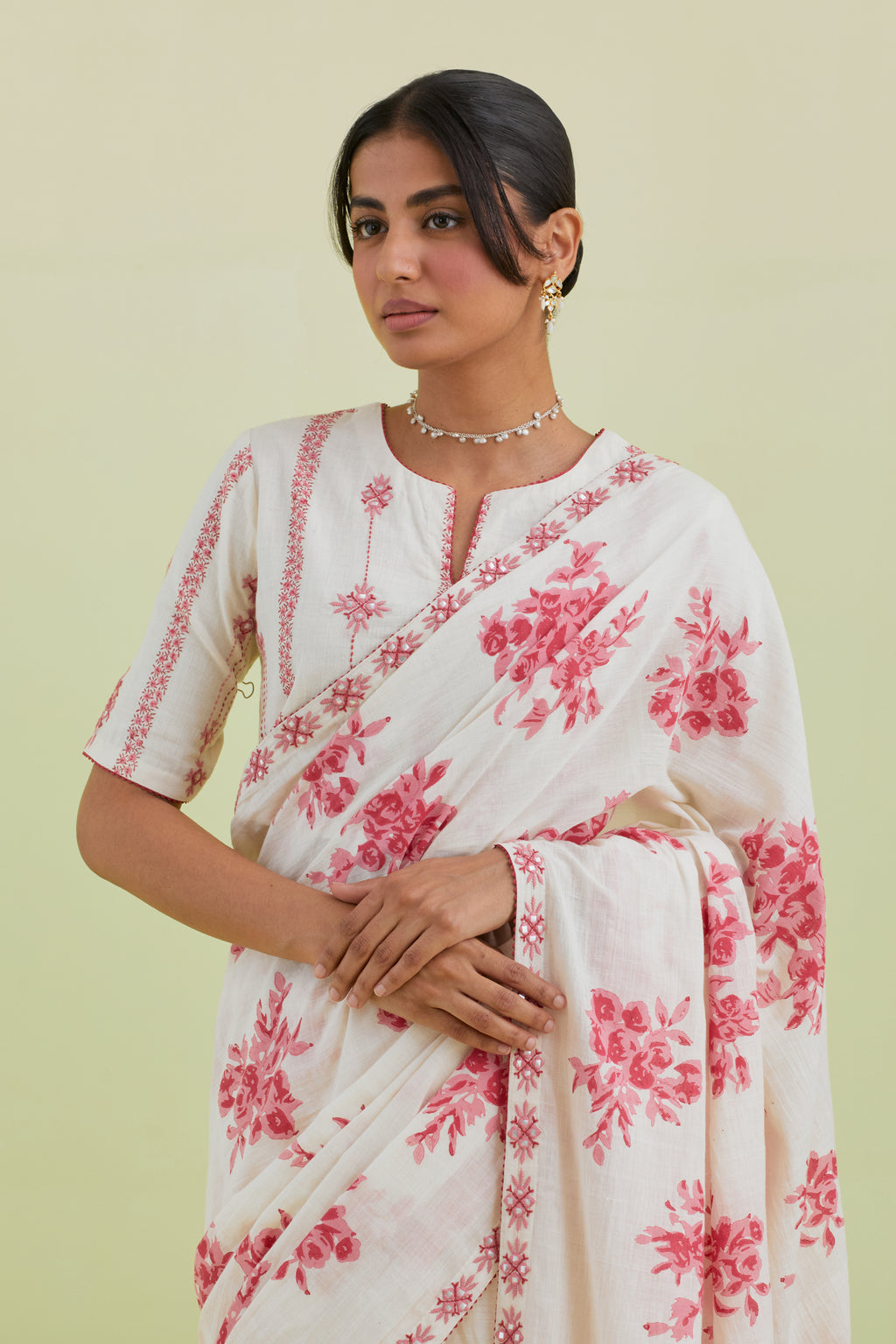 Pink & off-white handspun handwoven cotton hand-block printed saree set with pink thread and mirror embroidery at the edges.