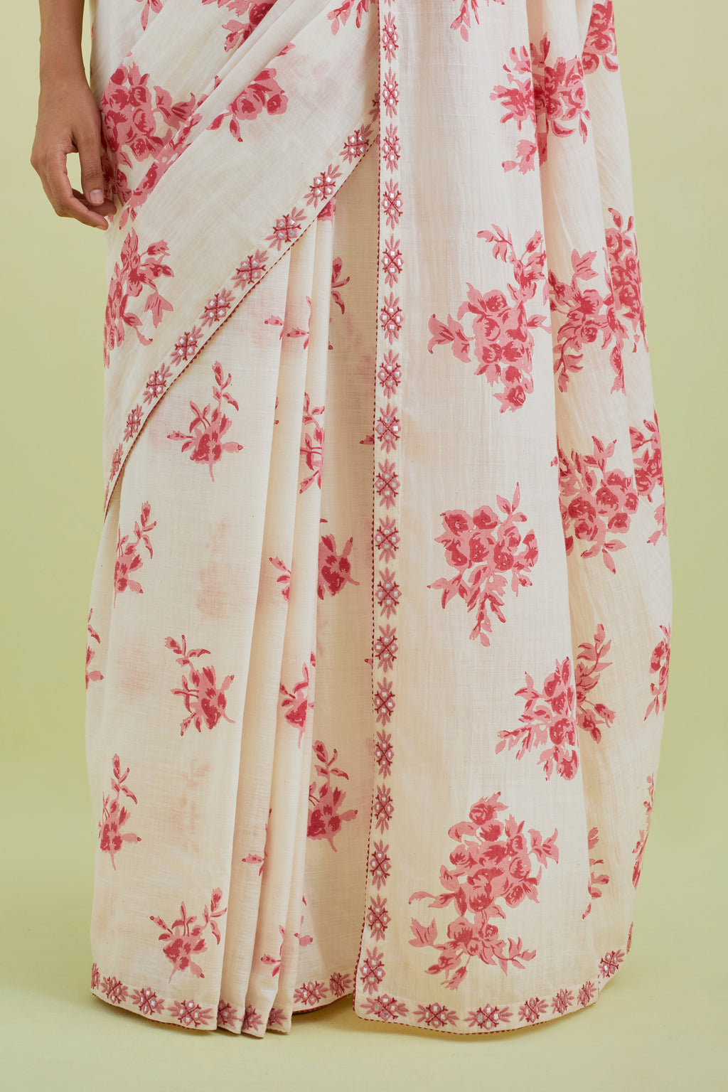 Pink & off-white handspun handwoven cotton hand-block printed saree set with pink thread and mirror embroidery at the edges.