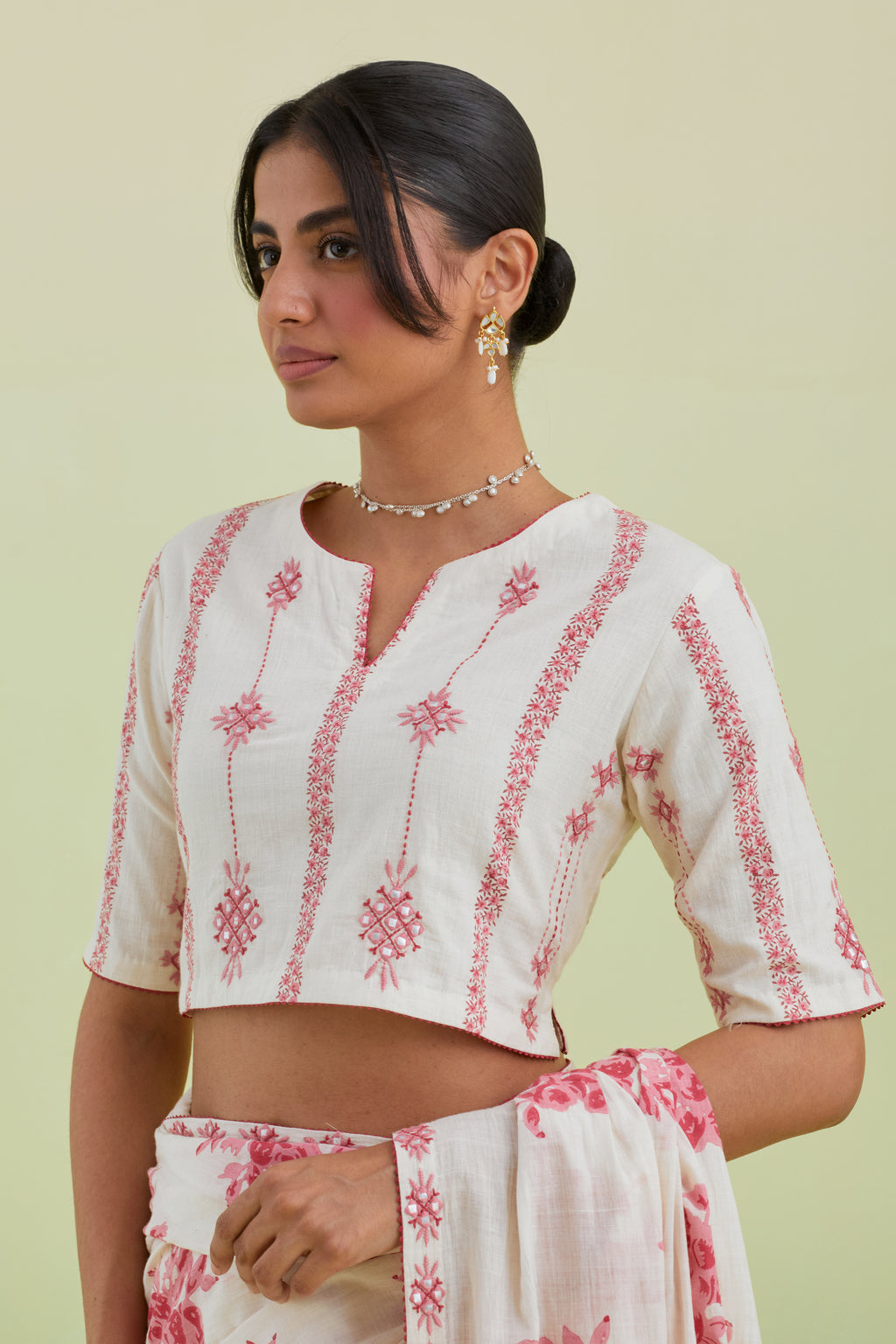 Pink and off-white hand block printed cotton blouse with thread and mirror embroidery along with kantha work.