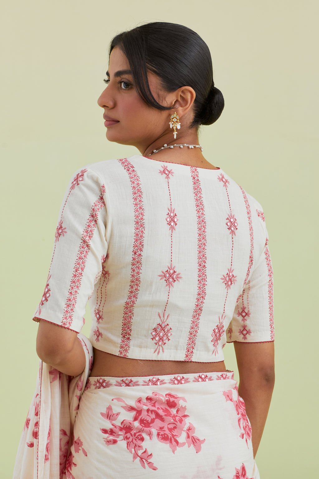 Pink and off-white hand block printed cotton blouse with thread and mirror embroidery along with kantha work.