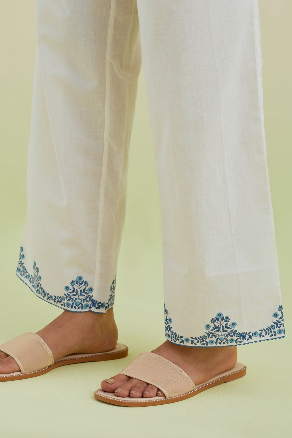 Off white straight pants with blue colored hand-block printed border at hem.