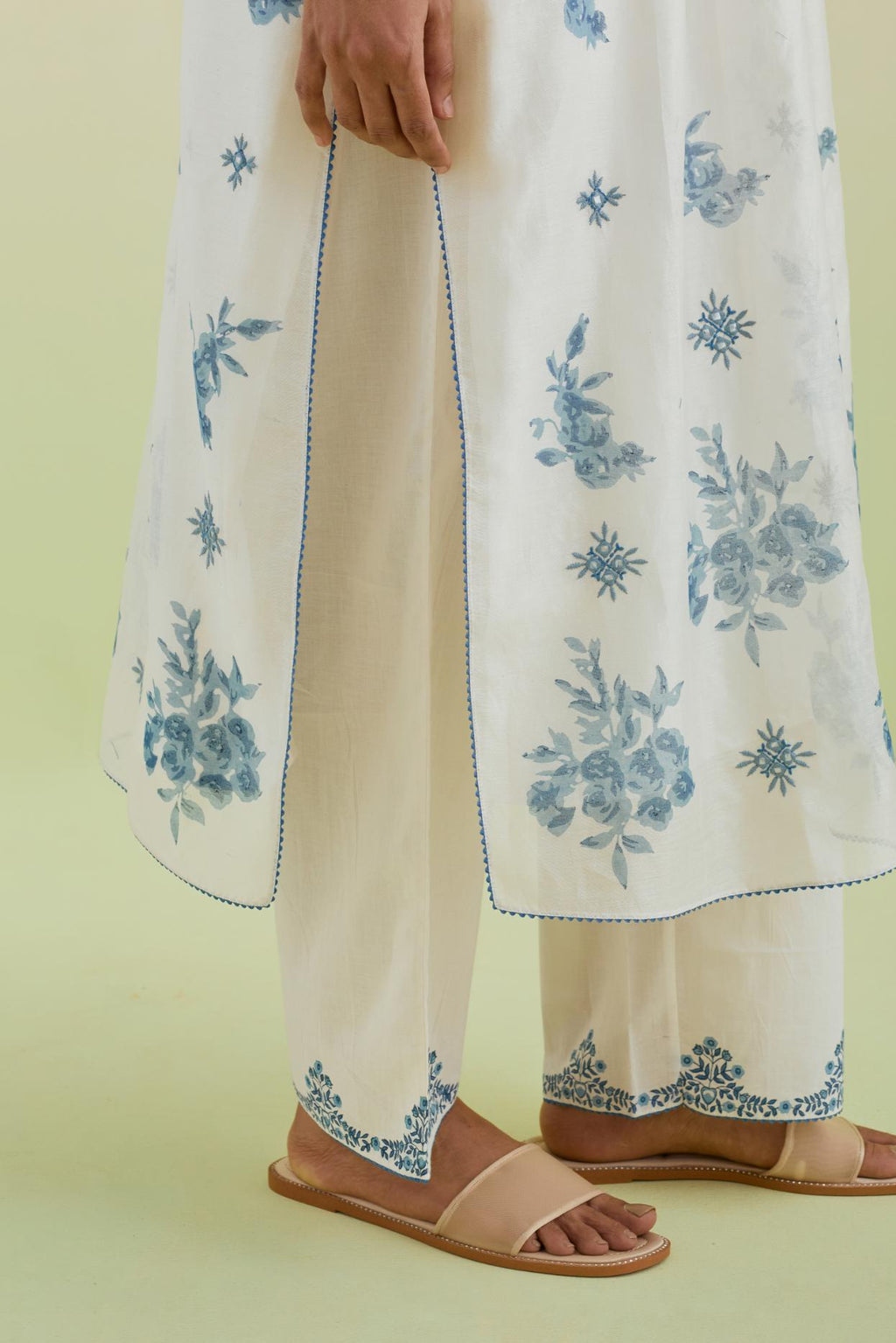 Blue and off-white silk chanderi hand block printed straight kurta set with pin tucks at yoke and all-over blue colored flower.