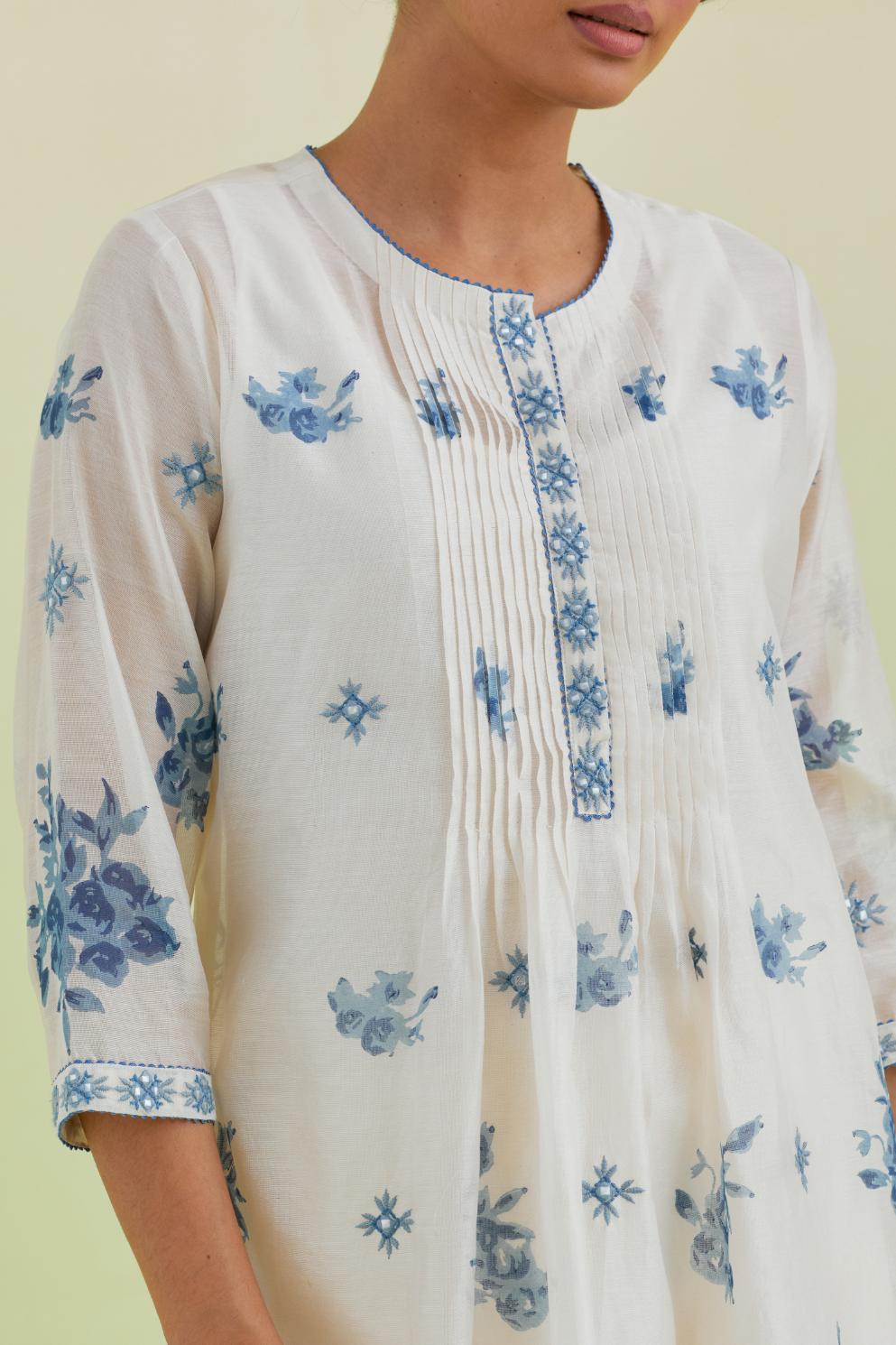 Blue and off-white silk chanderi hand block printed straight kurta set with pin tucks at yoke and all-over blue colored flower.