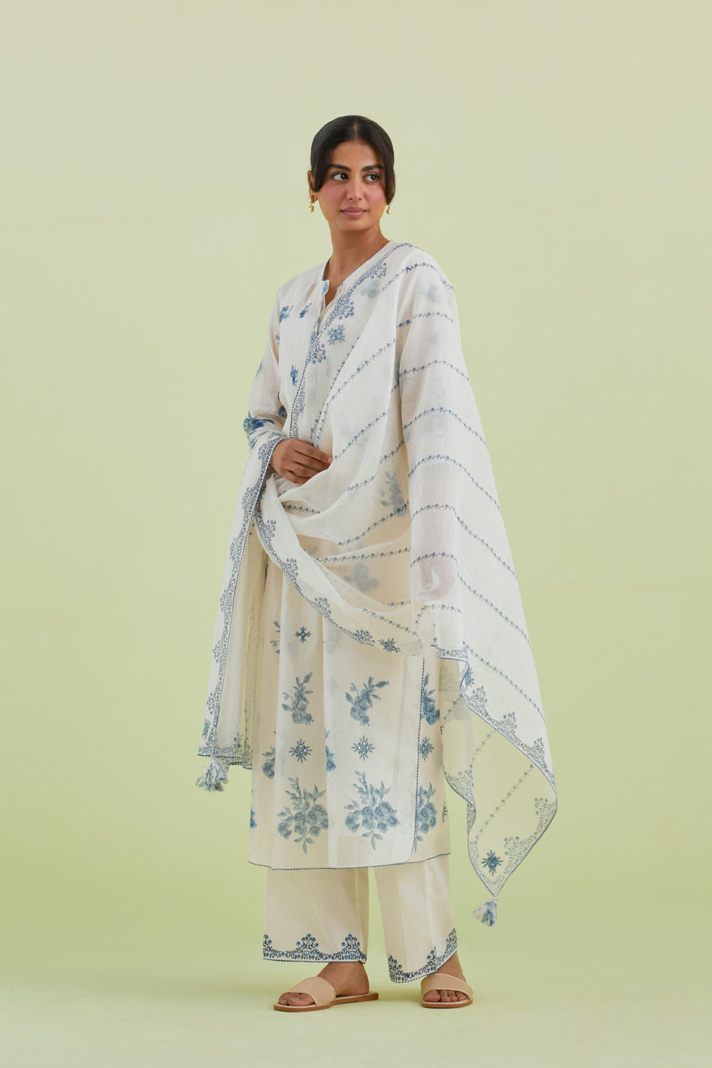 Blue and off-white silk chanderi hand block printed straight kurta set with pin tucks at yoke and all-over blue colored flower.