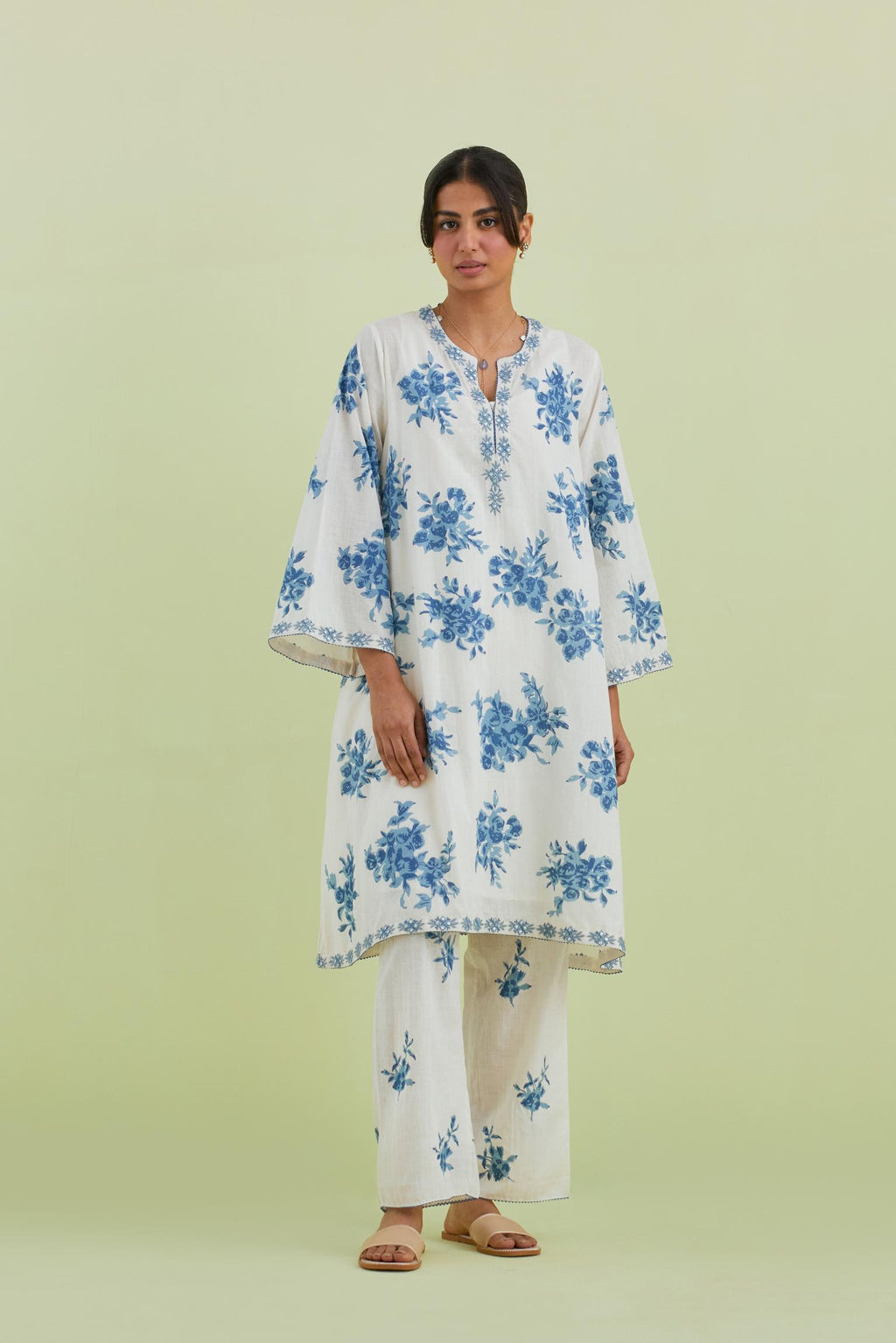 Blue and off-white cotton hand-block printed A-line short kurta set with round neck and asymmetric hem.