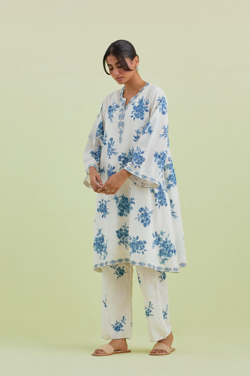 Blue and off-white cotton hand-block printed A-line short kurta set with round neck and asymmetric hem.