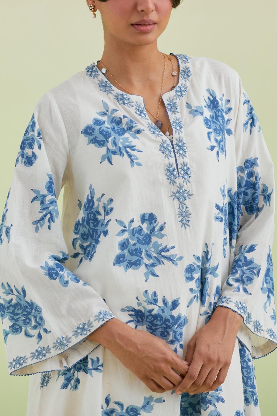 Blue and off-white cotton hand-block printed A-line short kurta set with round neck and asymmetric hem.