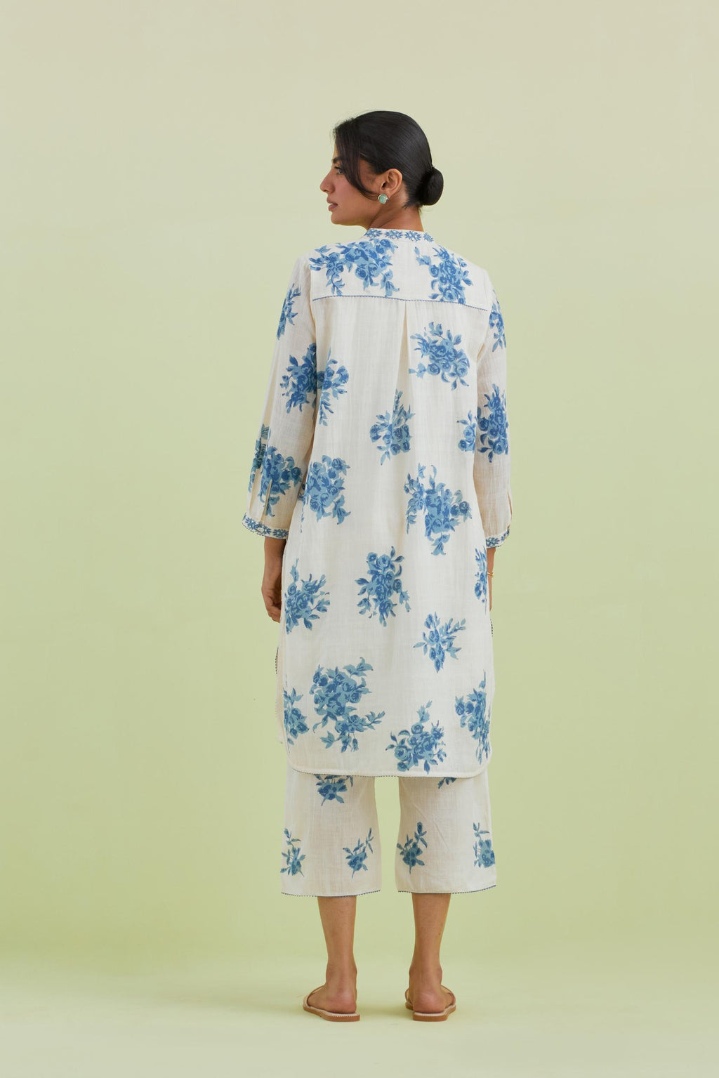 Blue and off-white cotton straight short kurta with all-over hand block print and embroidery at neck and sleeves, paired with off white straight ankle length pants with all-over blue colored floral boota hand-block print.