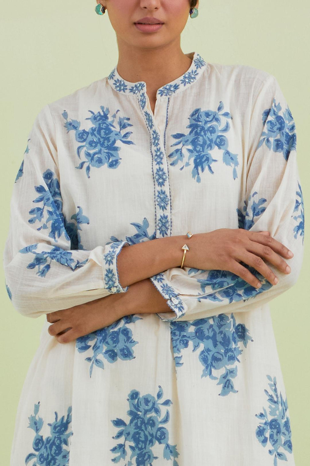 Blue and off-white cotton straight short kurta with all-over hand block print and embroidery at neck and sleeves, paired with off white straight ankle length pants with all-over blue colored floral boota hand-block print.