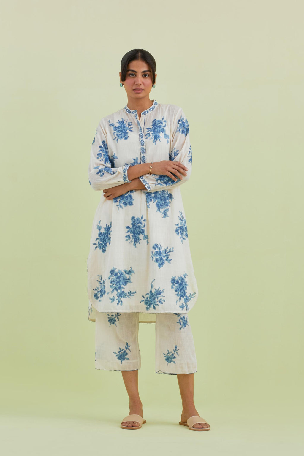 Blue and off-white cotton straight short kurta with all-over hand block print and embroidery at neck and sleeves, paired with off white straight ankle length pants with all-over blue colored floral boota hand-block print.