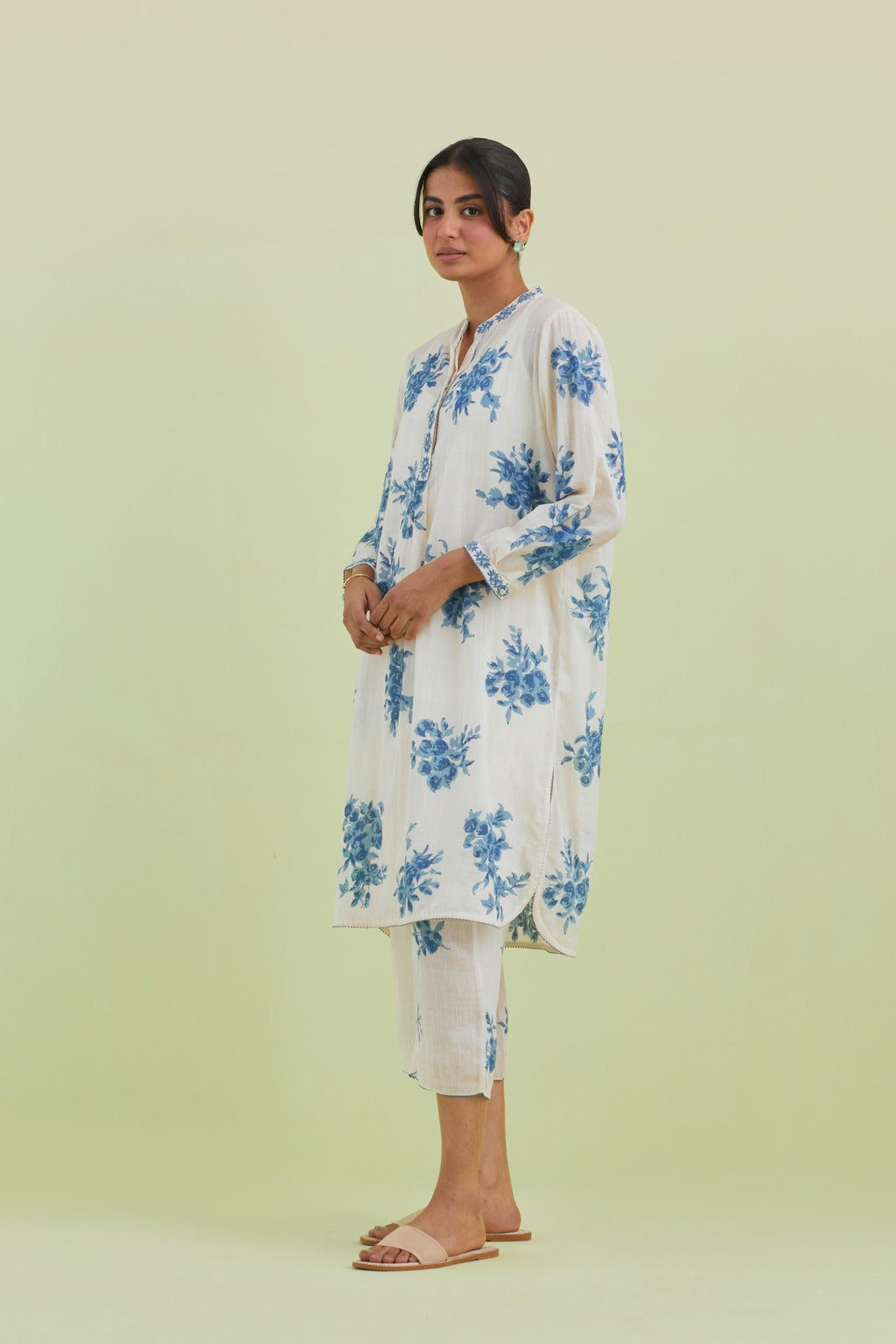 Blue and off-white cotton straight short kurta with all-over hand block print and embroidery at neck and sleeves, paired with off white straight ankle length pants with all-over blue colored floral boota hand-block print.