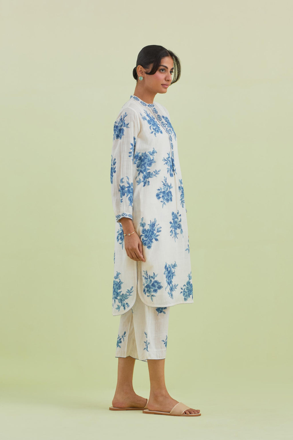 Blue and off-white cotton straight short kurta with all-over hand block print and embroidery at neck and sleeves, paired with off white straight ankle length pants with all-over blue colored floral boota hand-block print.