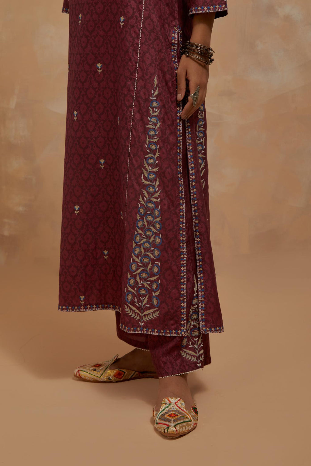 Deep berry silk hand block printed kalidar straight kurta set, highlighted with multi colored silk thread embroidery.