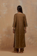 Olive green silk hand block printed kalidar straight kurta set, highlighted with multi colored silk thread embroidery.