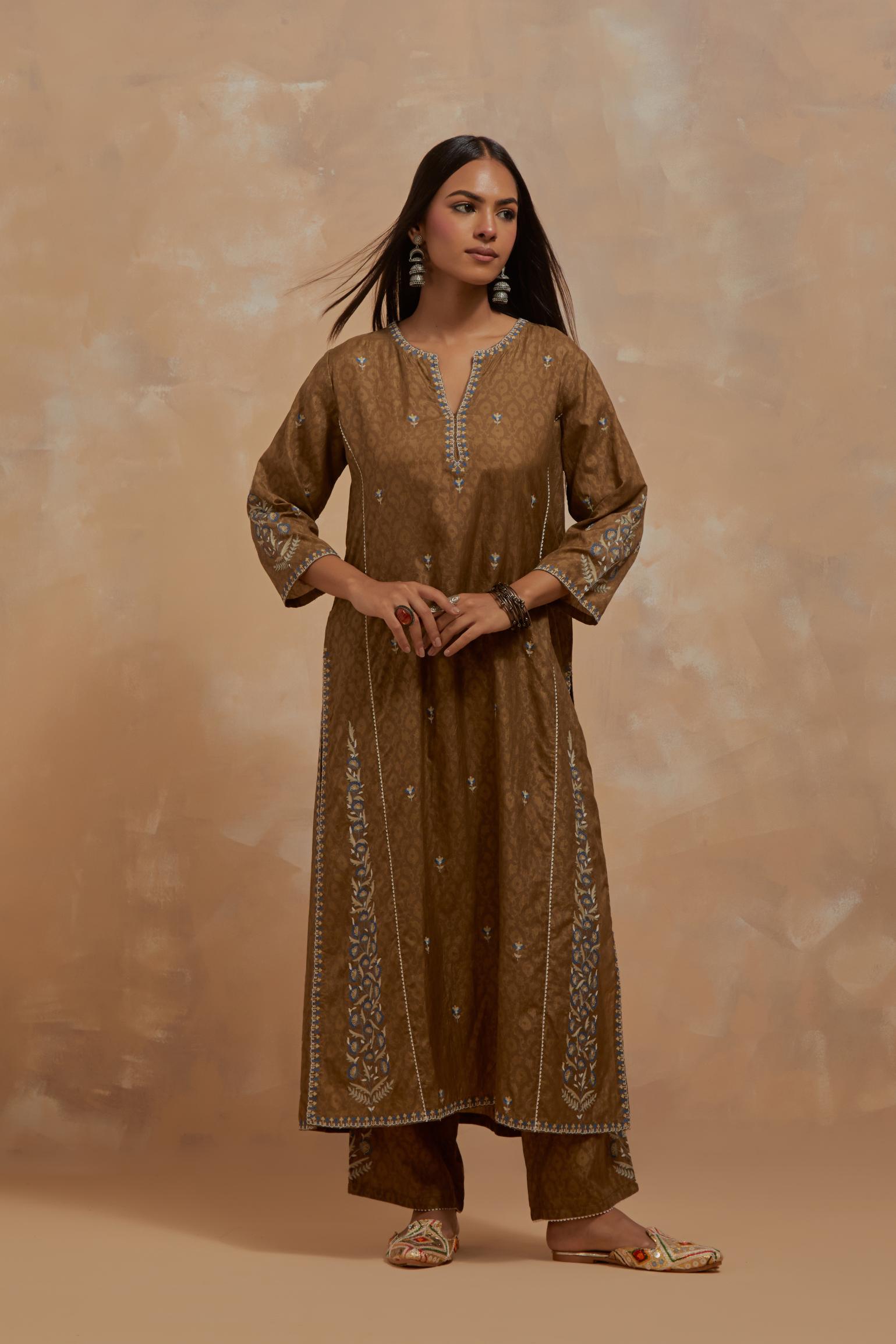 Olive green silk hand block printed kalidar straight kurta set, highlighted with multi colored silk thread embroidery.