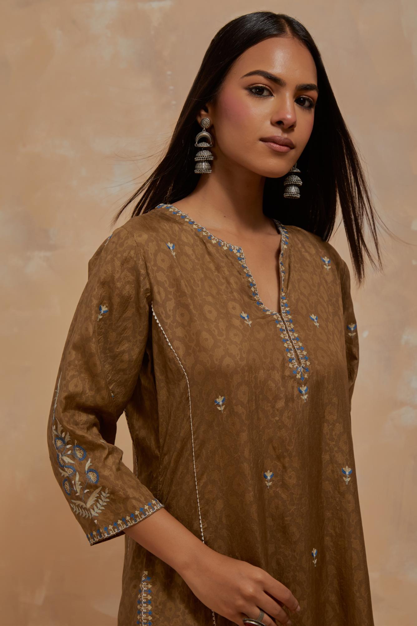 Olive green silk hand block printed kalidar straight kurta set, highlighted with multi colored silk thread embroidery.