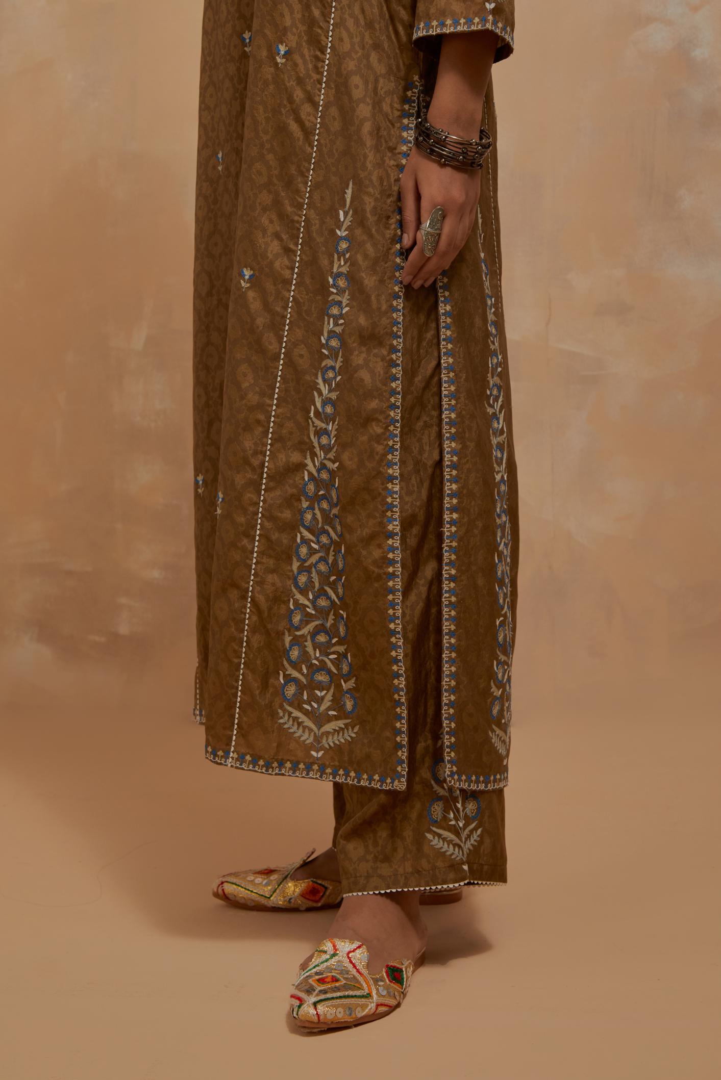 Olive green silk hand block printed kalidar straight kurta set, highlighted with multi colored silk thread embroidery.