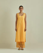 Yellow cotton chanderi straight kurta set with yoke and side panels. It has allover patchwork and silk thread embroidery, highlighted with mirror, sequins, tassels and braids.
