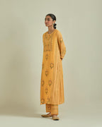Yellow cotton chanderi straight kurta set with yoke and side panels. It has allover patchwork and silk thread embroidery, highlighted with mirror, sequins, tassels and braids.