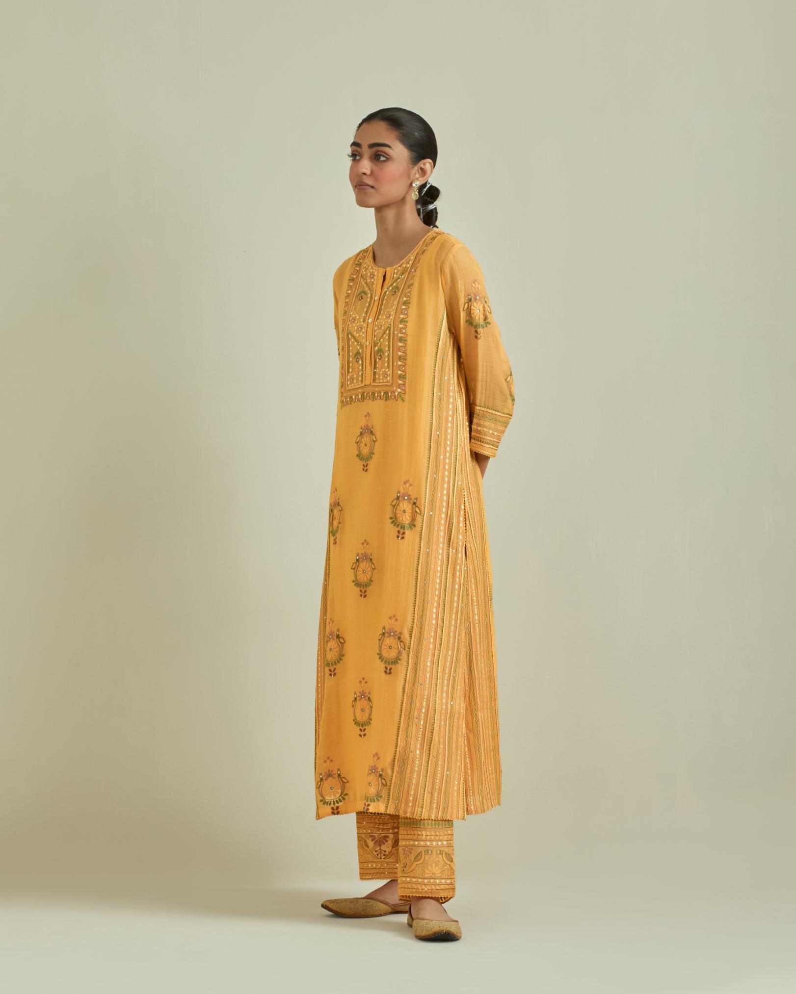 Yellow cotton chanderi straight kurta set with yoke and side panels. It has allover patchwork and silk thread embroidery, highlighted with mirror, sequins, tassels and braids.