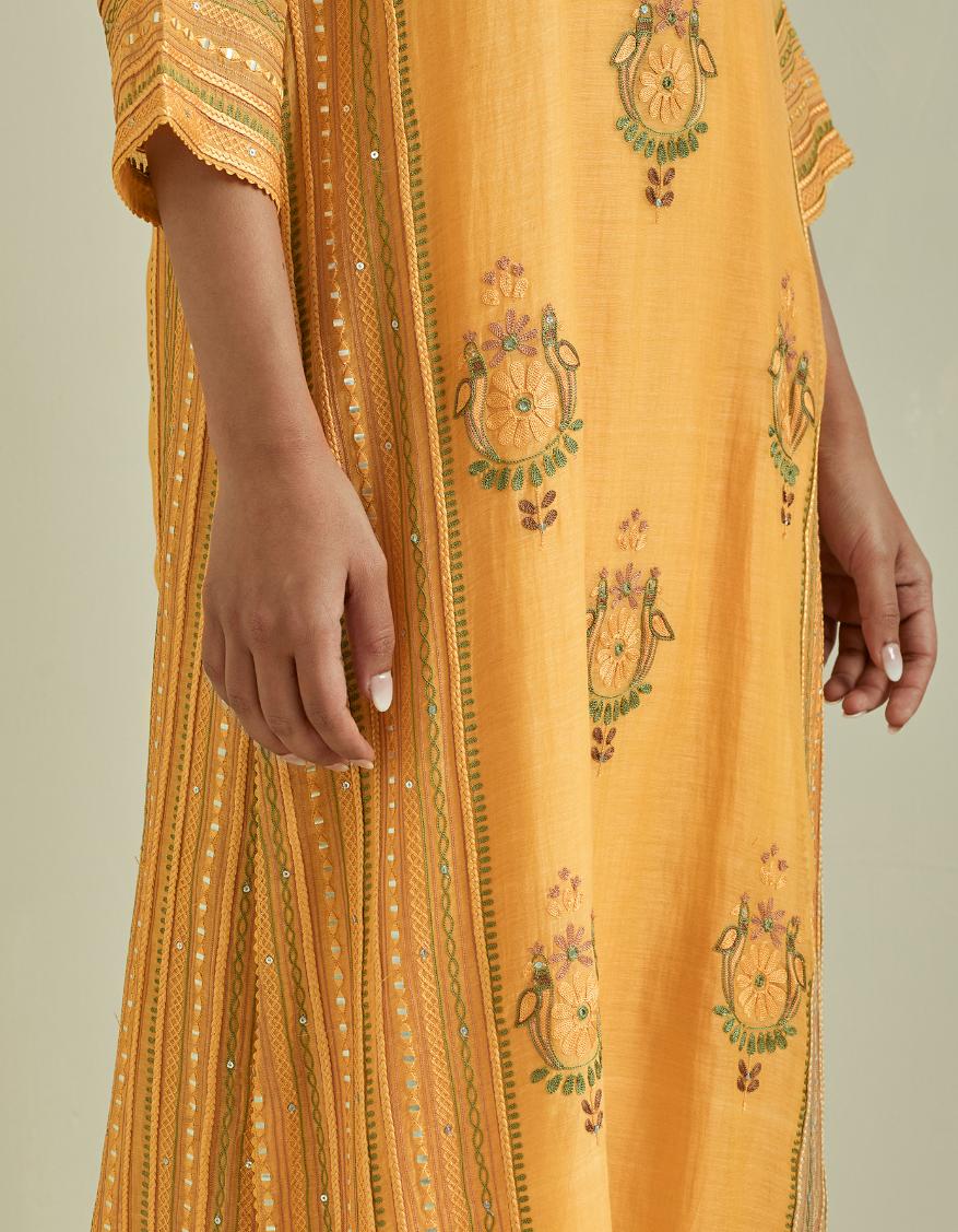 Yellow cotton chanderi straight kurta set with yoke and side panels. It has allover patchwork and silk thread embroidery, highlighted with mirror, sequins, tassels and braids.